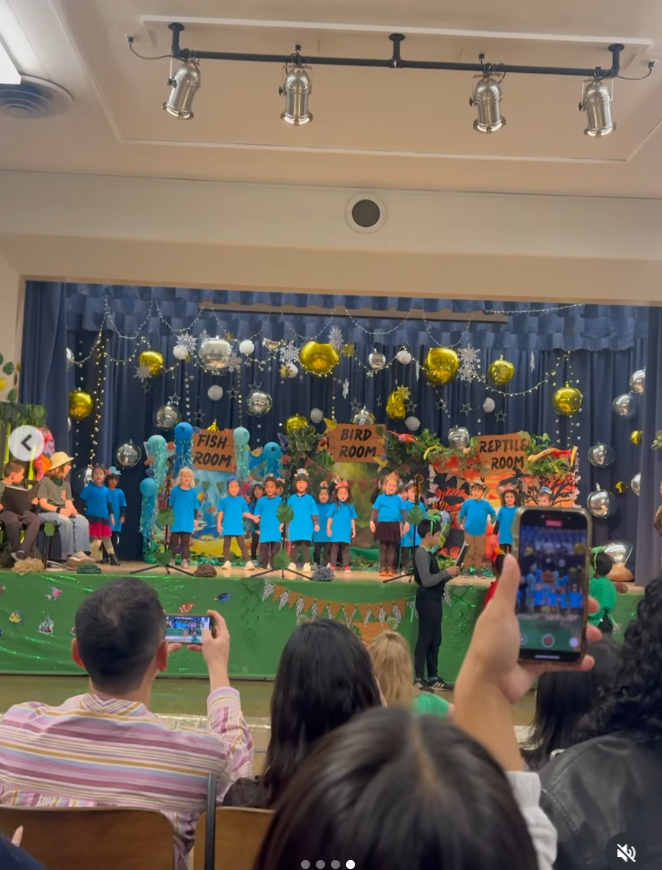 A wide shot shows Everest and her classmates on stage mid-performance, dressed in blue as they perform their school play, from a Alex's post dated December 13, 2025. | Source: Instagram/xtinahuong