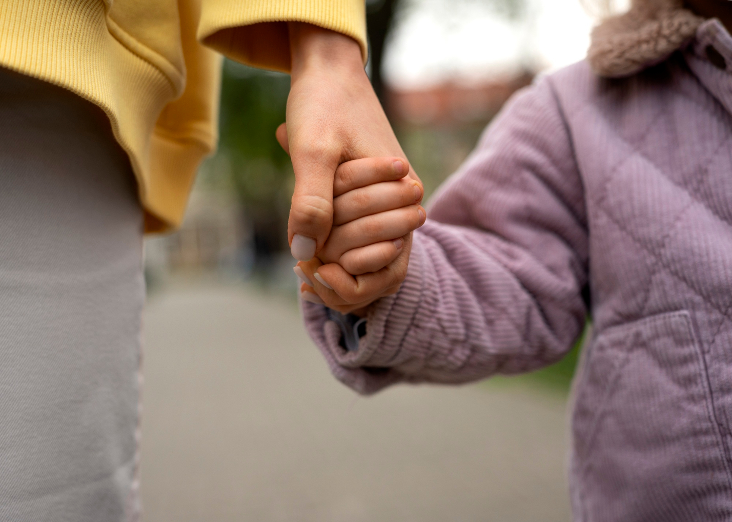 A mother holding her child's hand | Source: Freepik