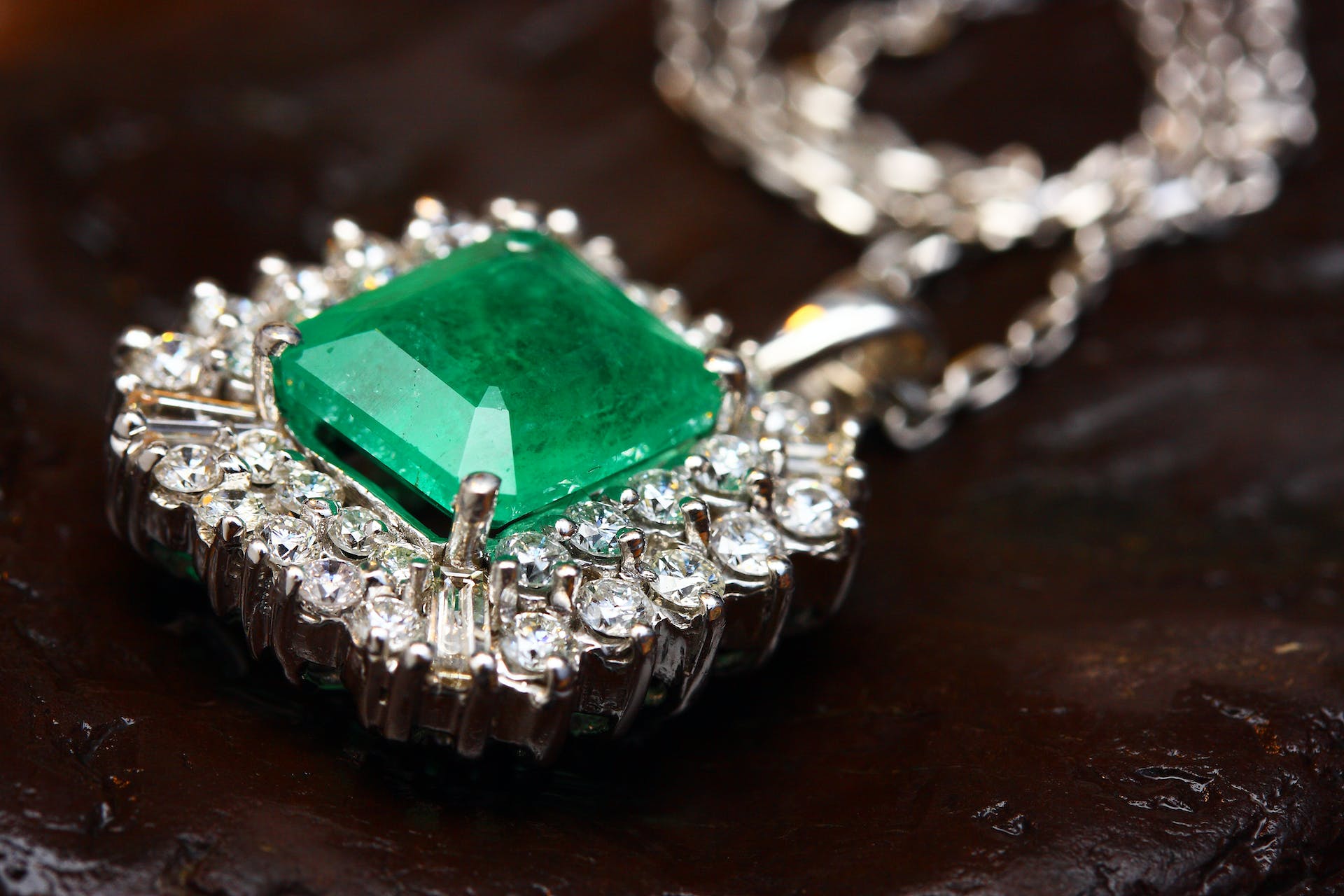 Silver-colored pendant with a green gemstone | Source: Pexels