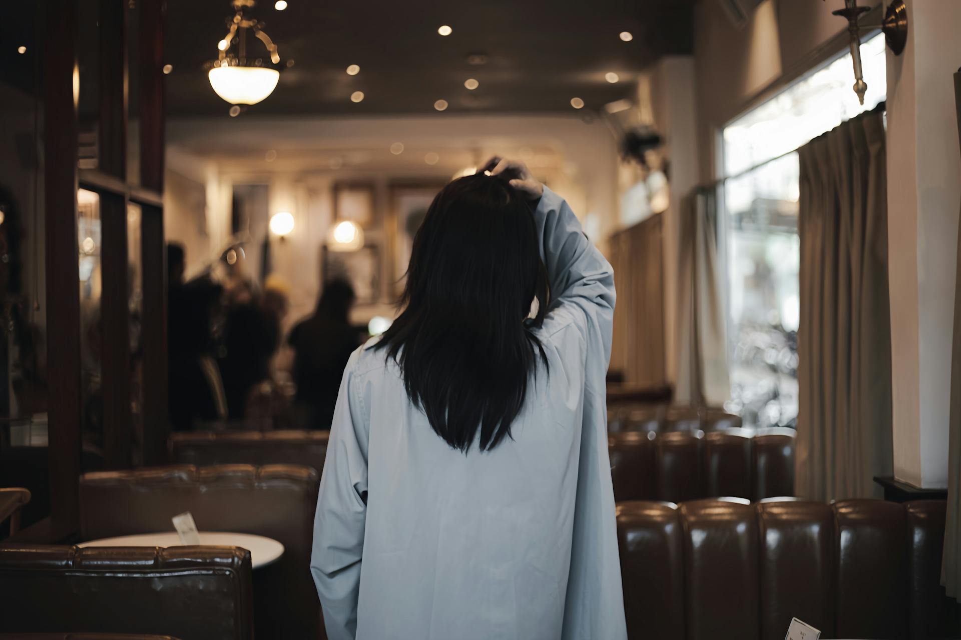 The back-view of a woman walking in a restaurant | Source: Pexels