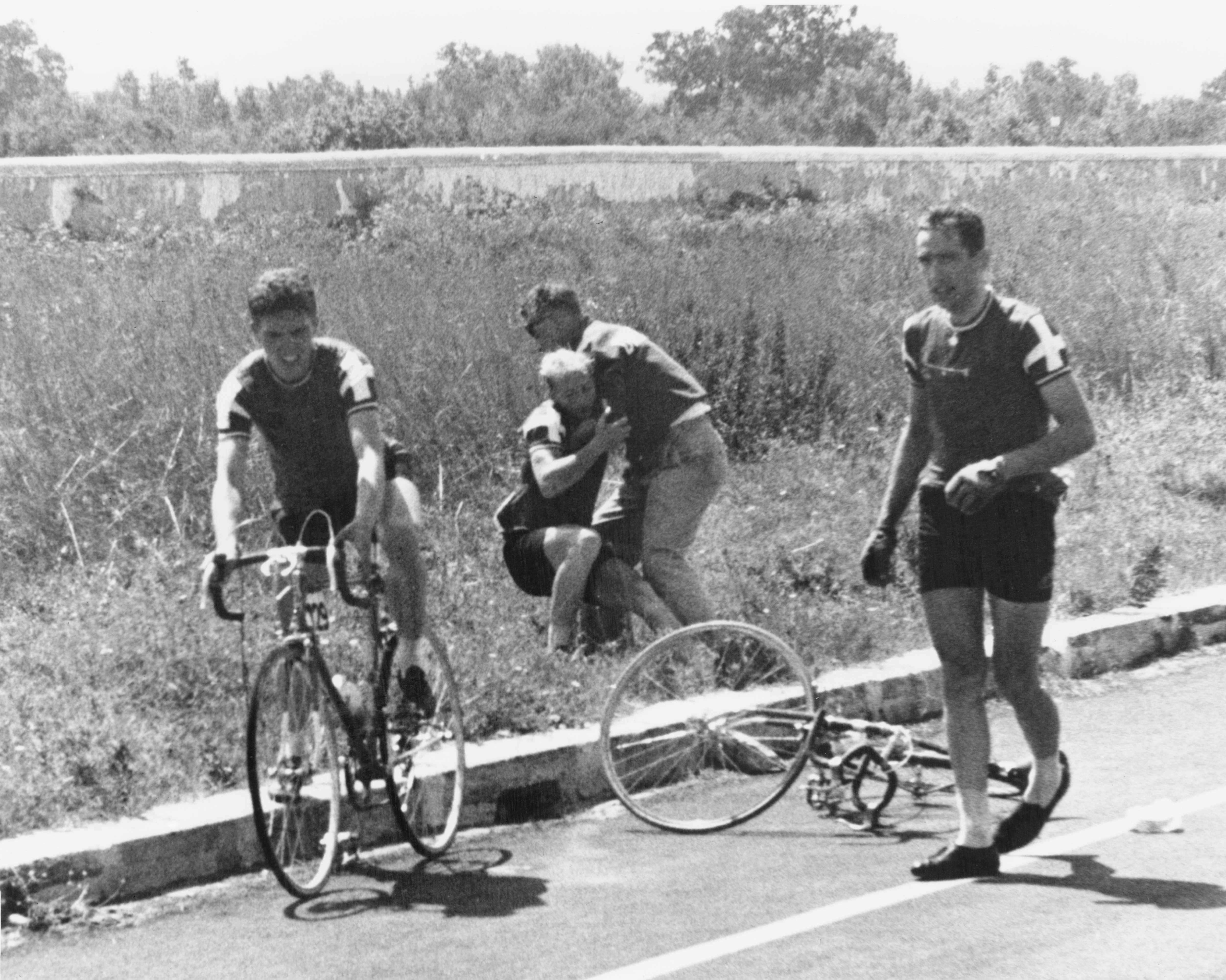 Danish cyclist Knud Enemark Jensen is carried, unconscious to the side of the road by a Danish official after collapsing with heat stroke and suffering a fractured skull at the Rome Olympics, on August 26, 1960 | Source: Getty Images