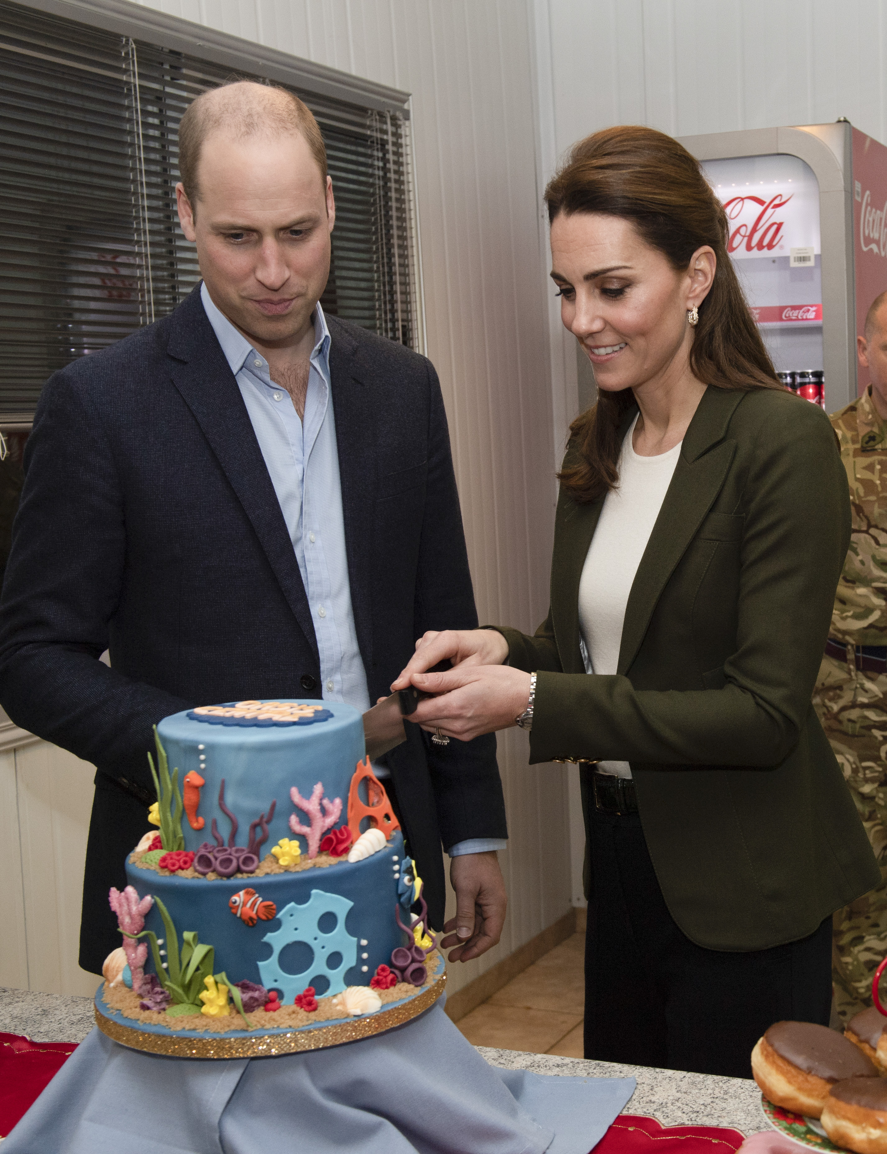 Prince William and Kate Middleton cutting a cake at the Oasis centre opening in Akrotiri, Cyprus on December 5, 2018 | Source: Getty Images