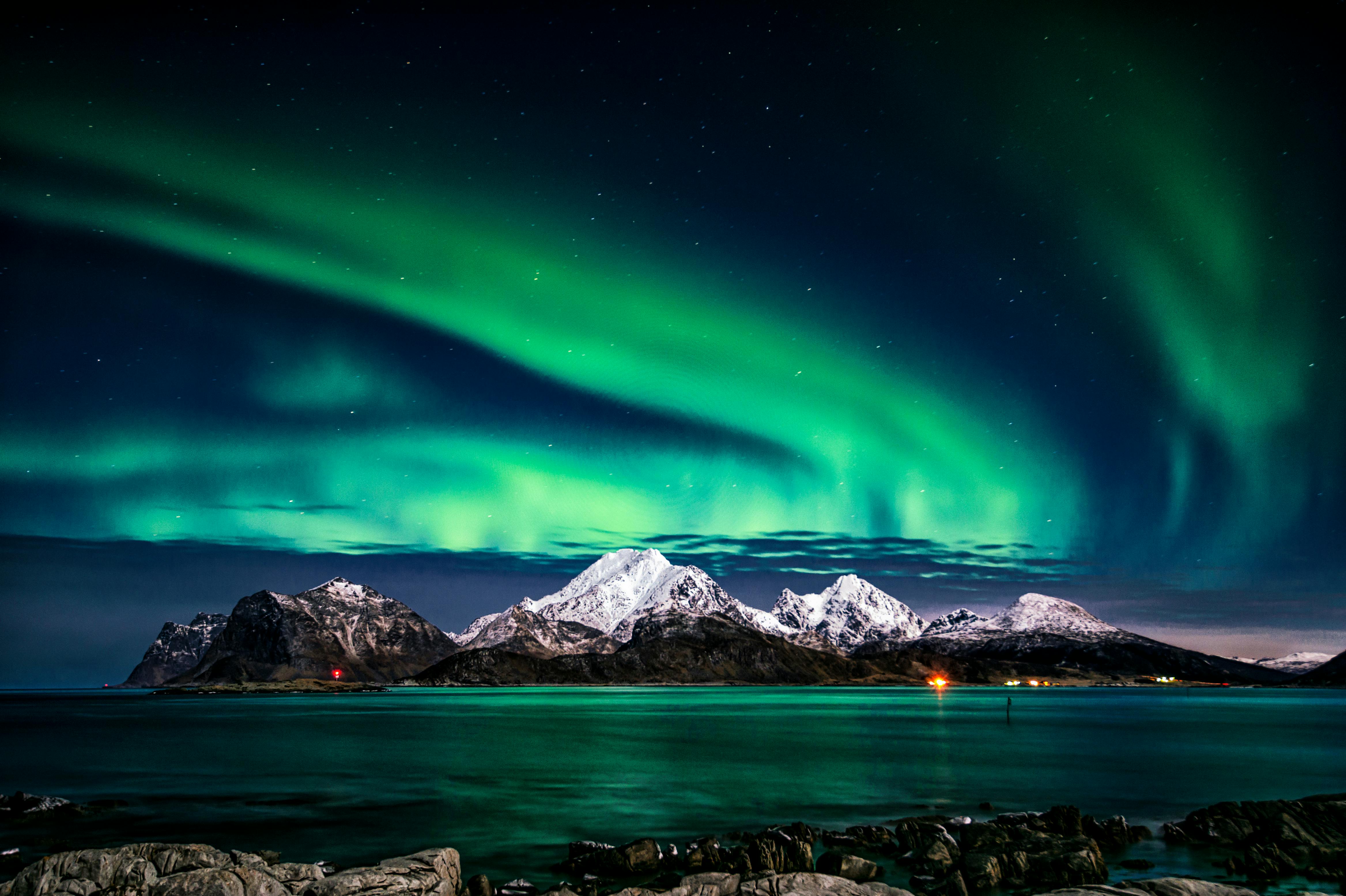 A shot of the northern lights behind mountains | Source: Pexels