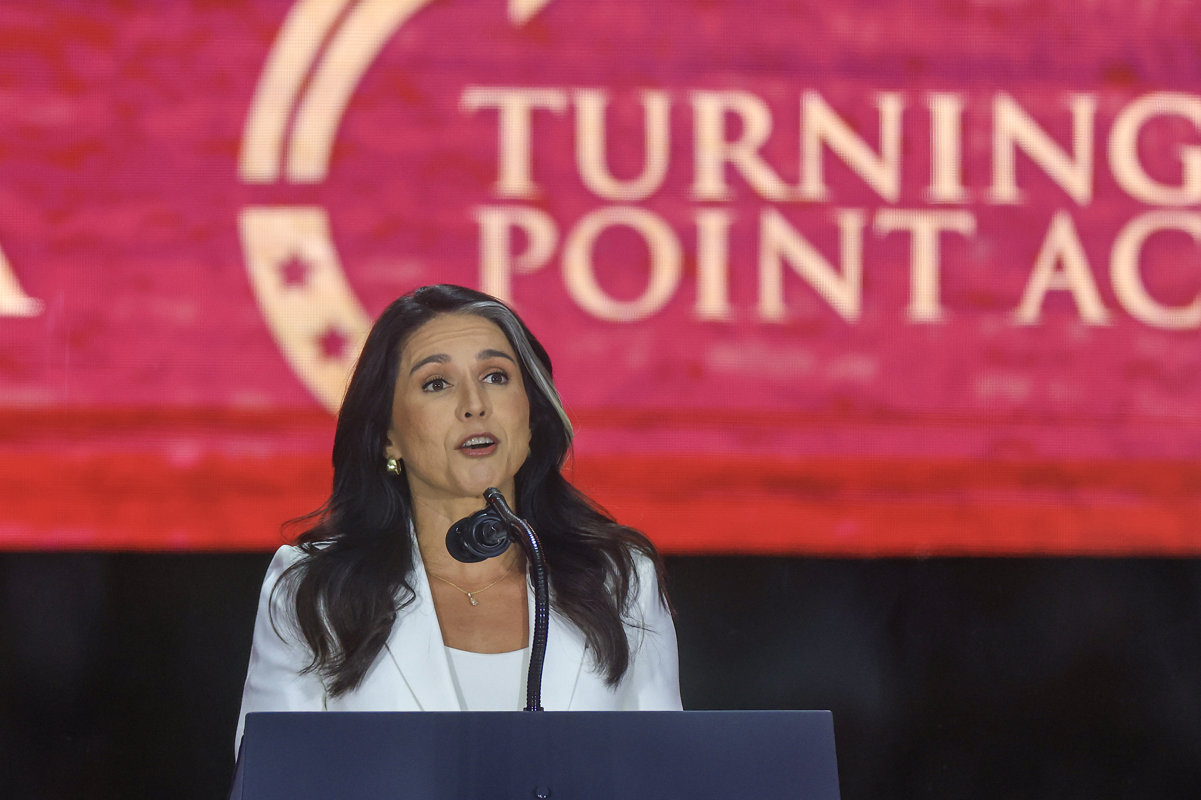 Director of National Intelligence Tulsi Gabbard speaks during the public memorial service for Charlie Kirk at State Farm Stadium on September 21, 2025 | Source: Getty Images