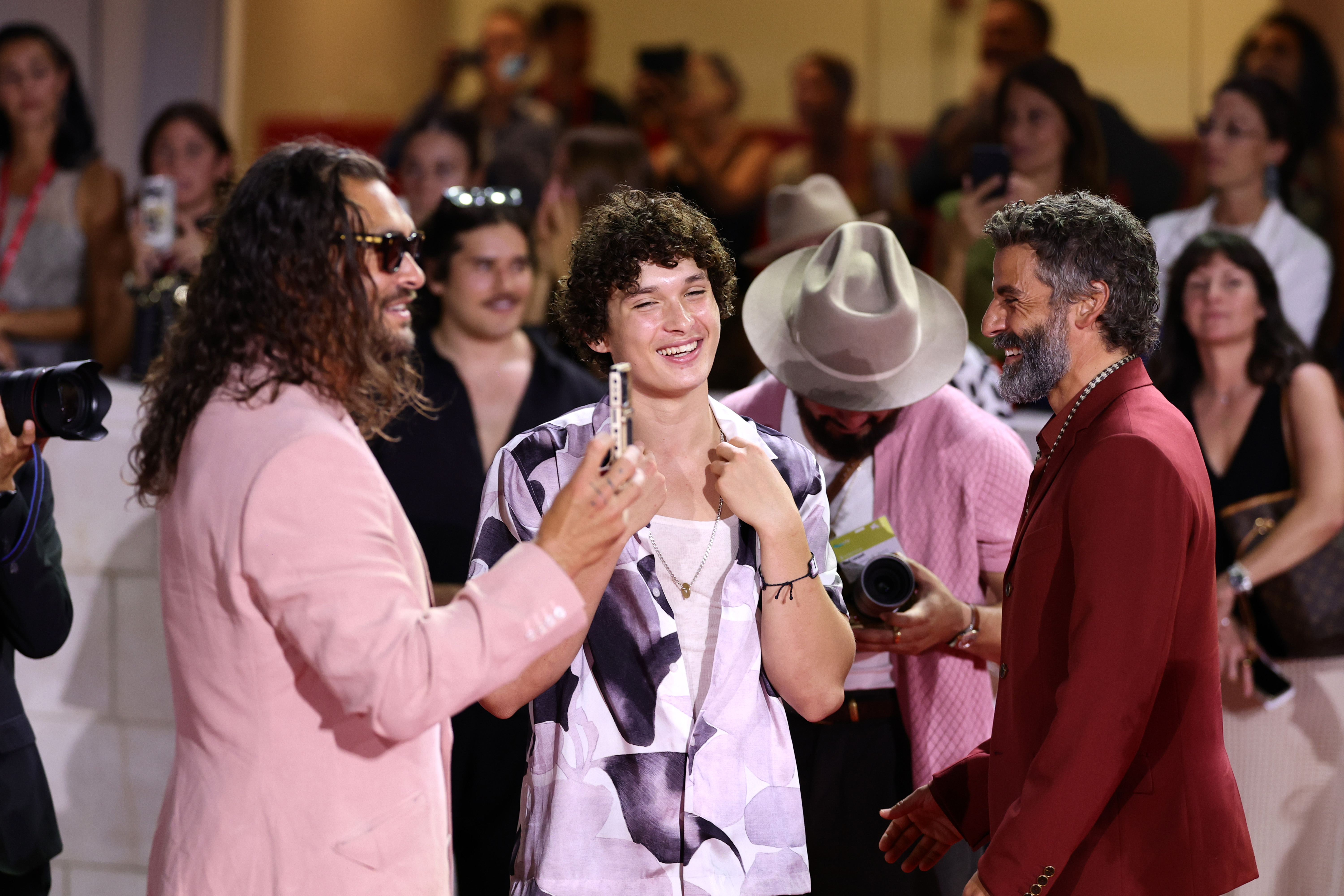 Breaking into laughter, Jason Momoa and Nakoa-Wolf Momoa shared an animated exchange with Oscar Isaac on the Venice red carpet, bringing playful energy to the Cartier Glory to the Filmmaker Award event.
