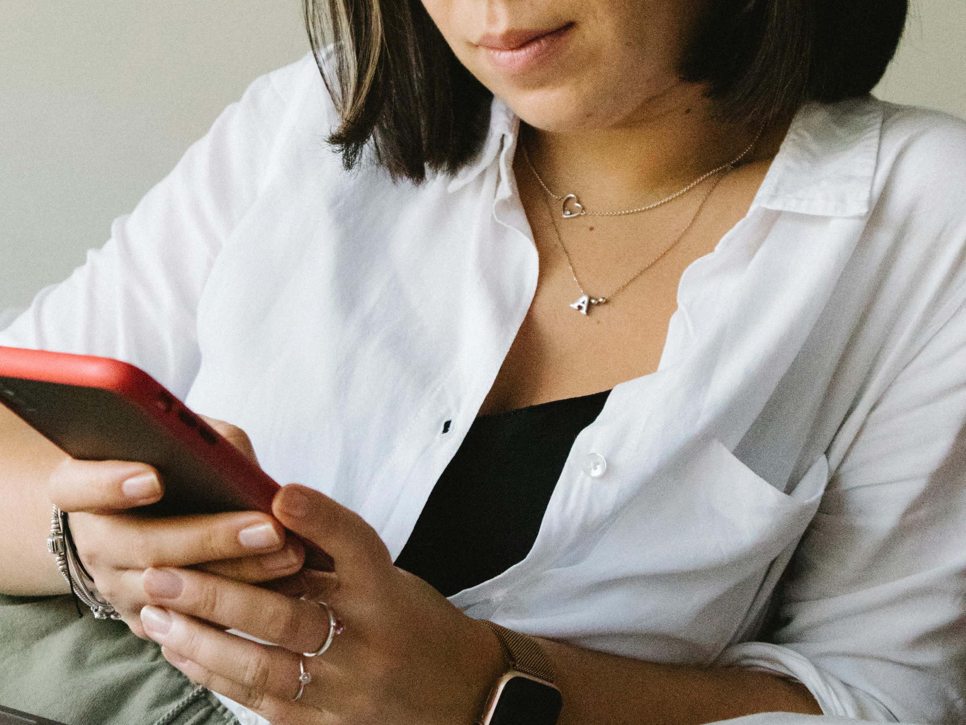 A young woman looking at her mobile phone | Source: Pexels