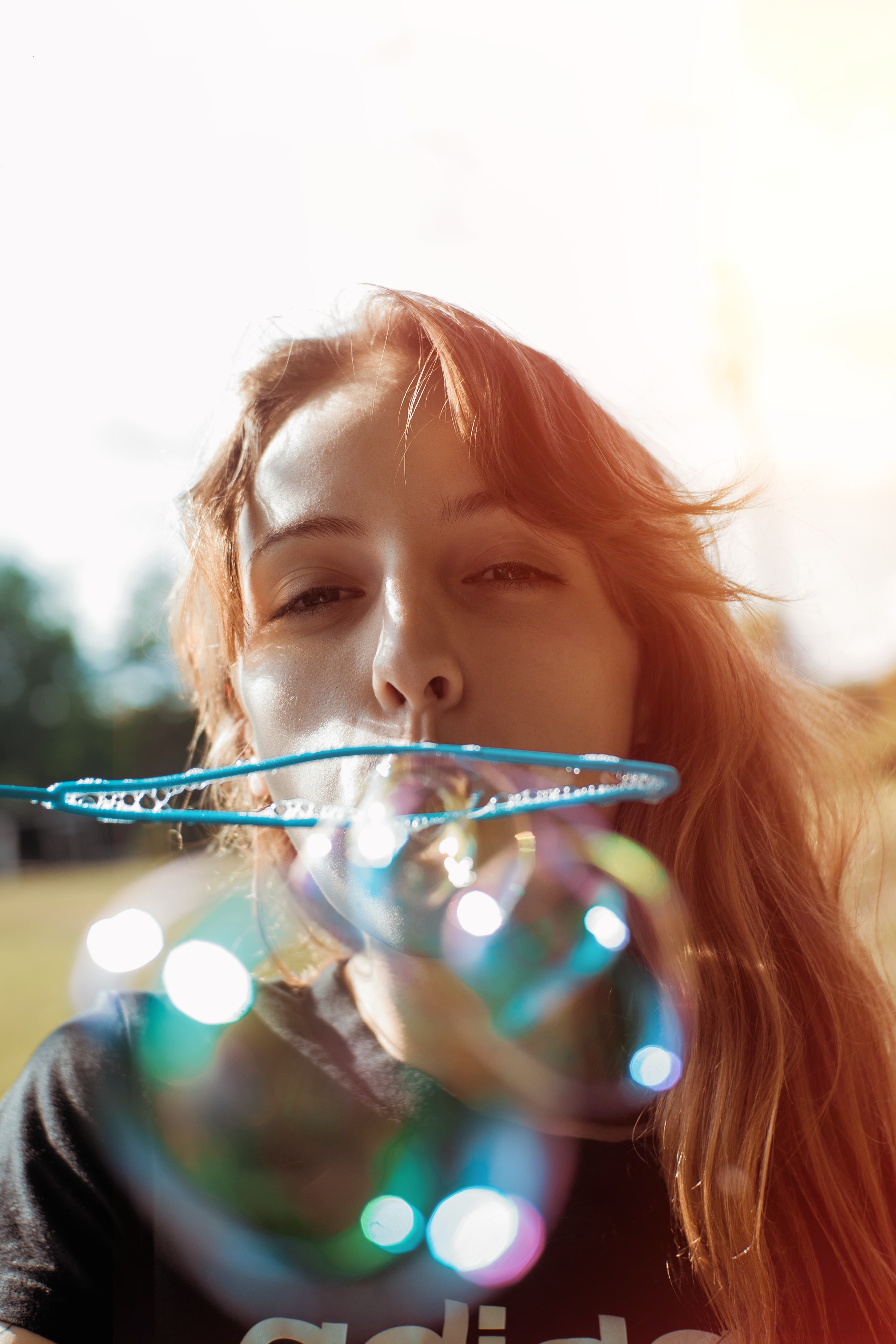 A woman blowing bubbles. | Source: Pexels