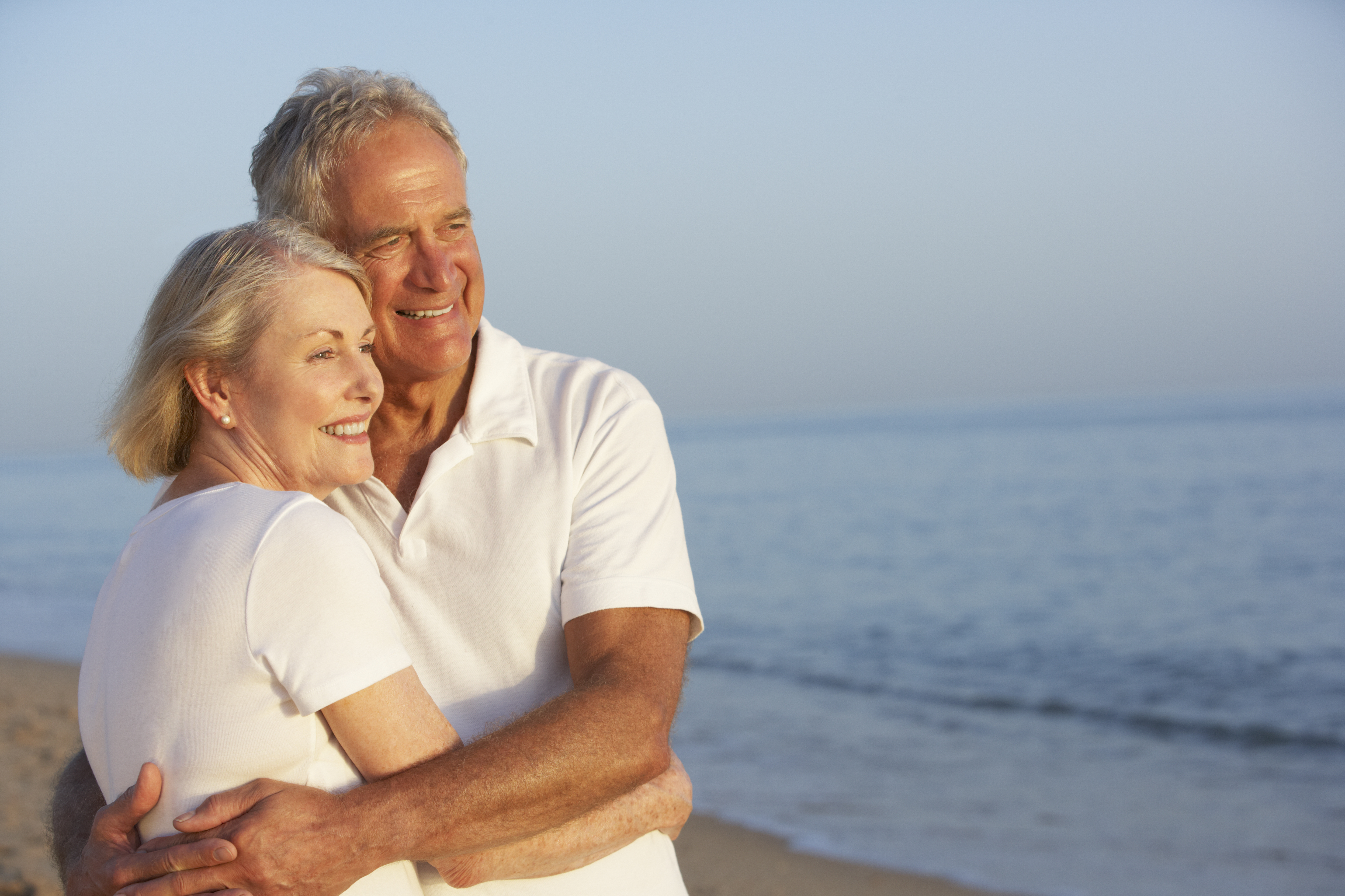 A happy older couple looking out at the ocean | Source: Shutterstock