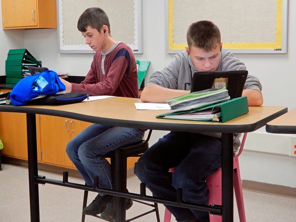 Two young students sitting at a high table using iPads in Science Class | Photo: Getty Images