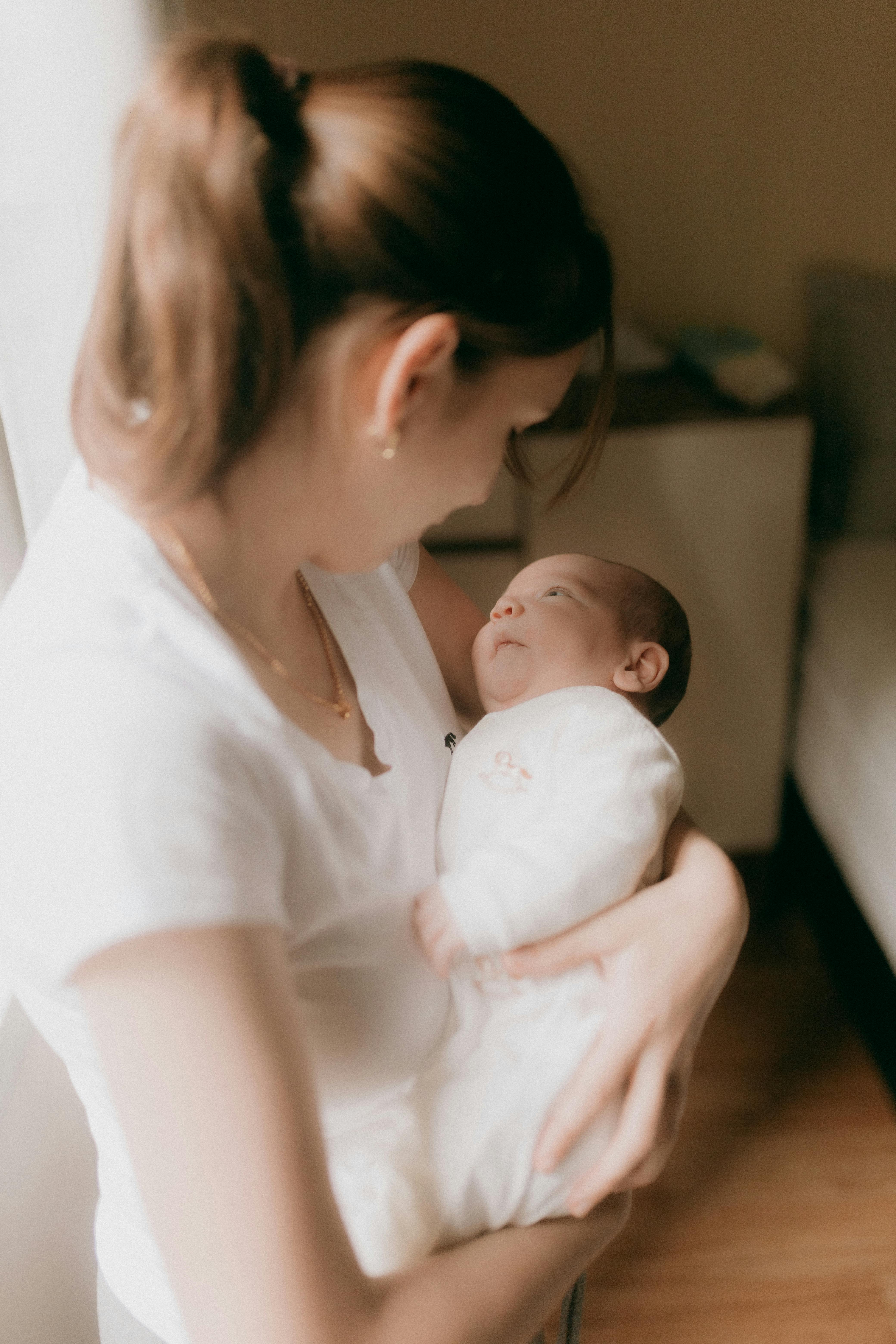 A mother cradling her baby | Source: Pexels