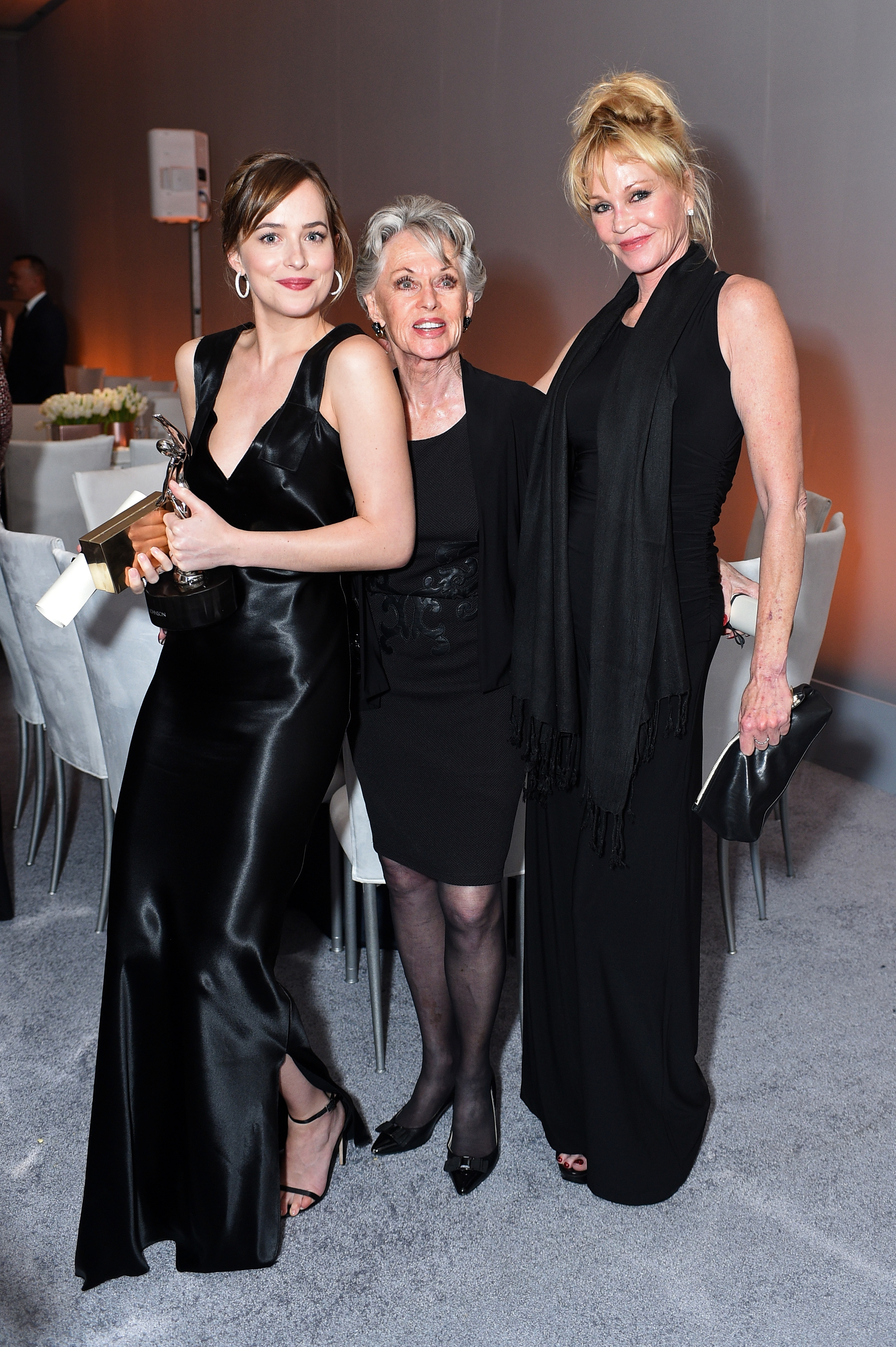 Dakota Johnson, Tippi Hedren and Melanie Griffith pose with the Calvin Klein Emerging Star Award during the 22nd Annual ELLE Women in Hollywood Awards at the Four Seasons Los Angeles at Beverly Hills on October 19, 2015 in Beverly Hills, California | Source: Getty Images