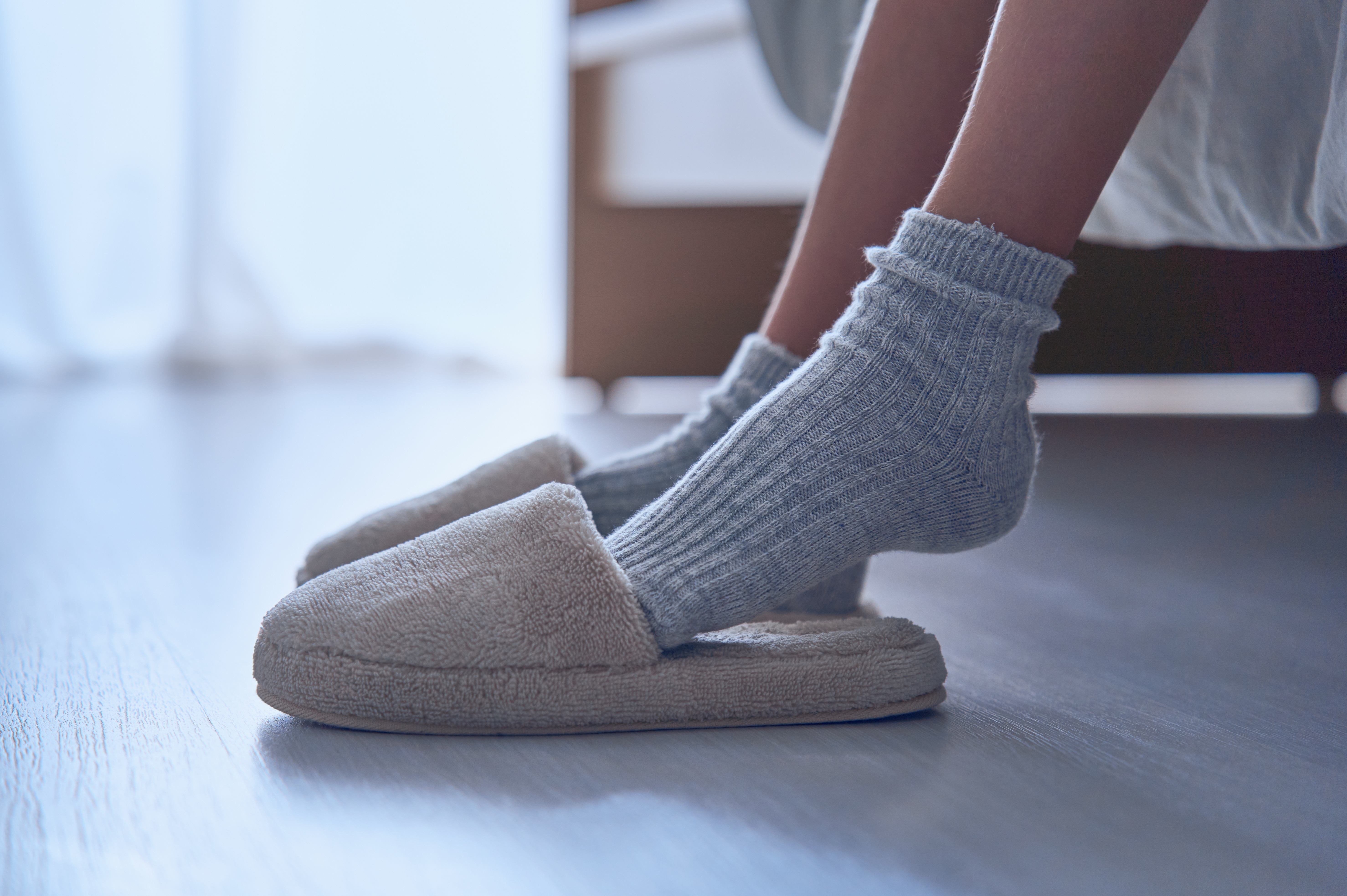 Children's feet in warm socks and slippers. | Source: Shutterstock