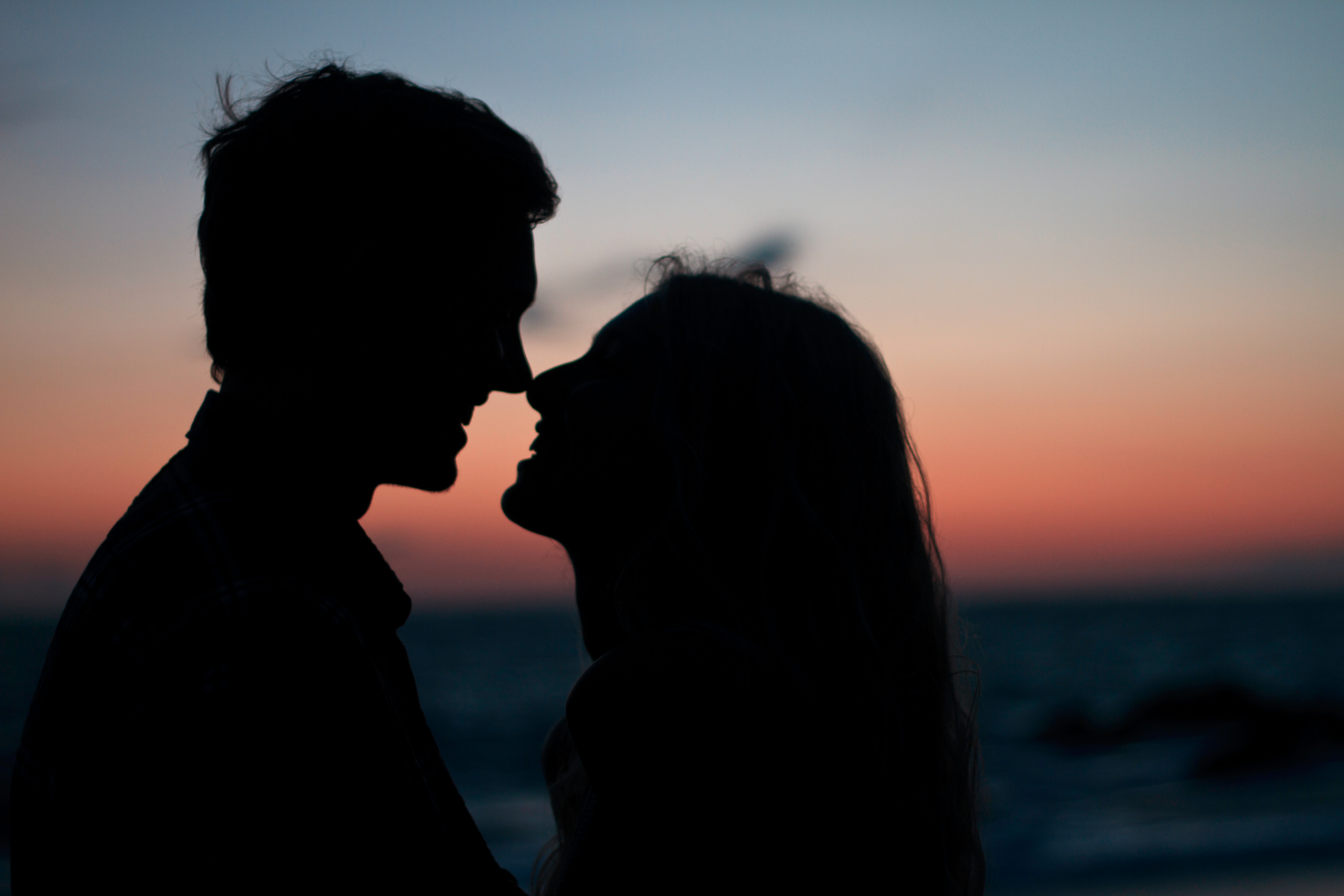 A silhouette of a man and a woman about to kiss on during sunset  | Source: Unsplash