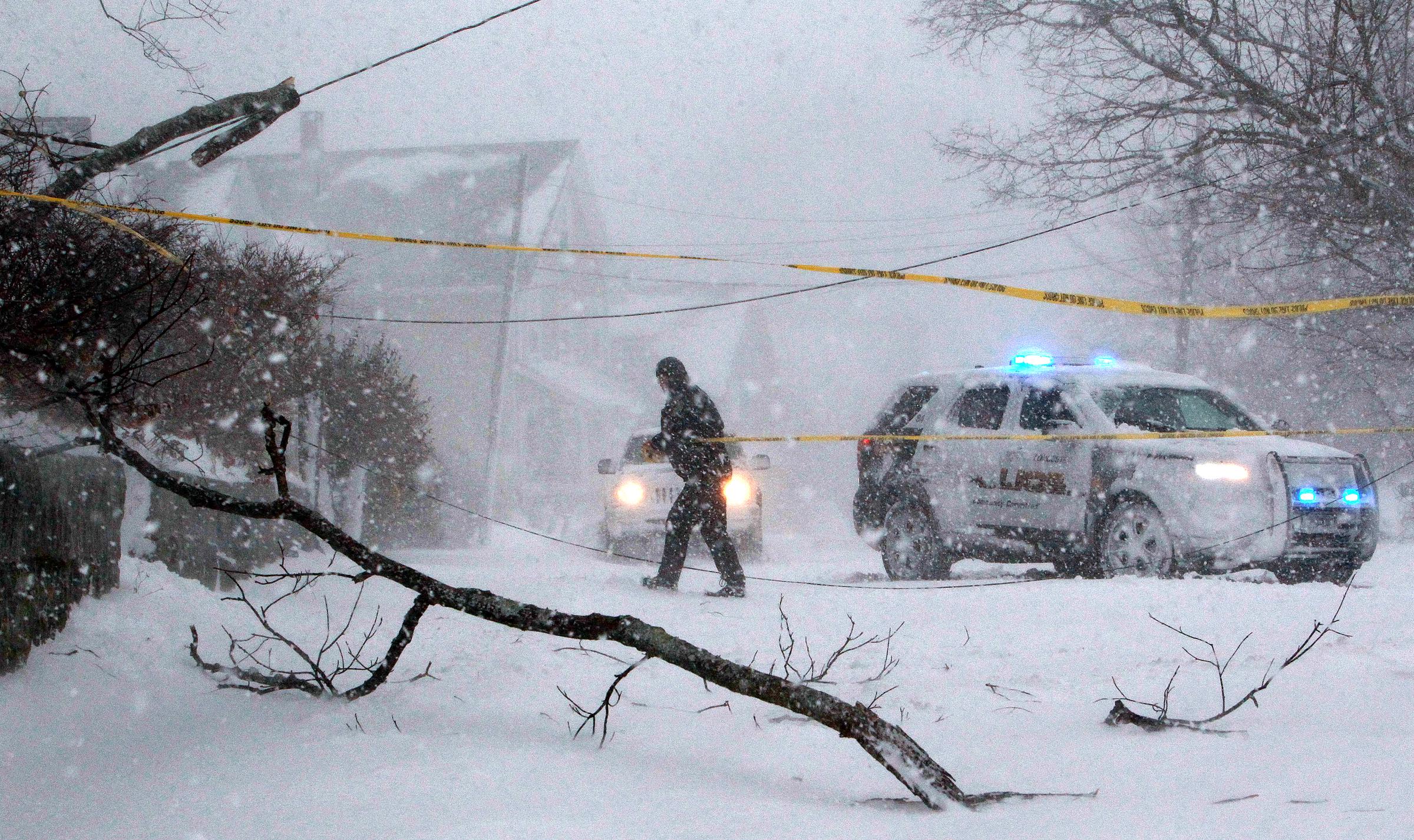 A police officer secures a scene where falling branches downed power lines on January 4, 2018, in Gloucester, Massachusetts. | Source: Getty Images