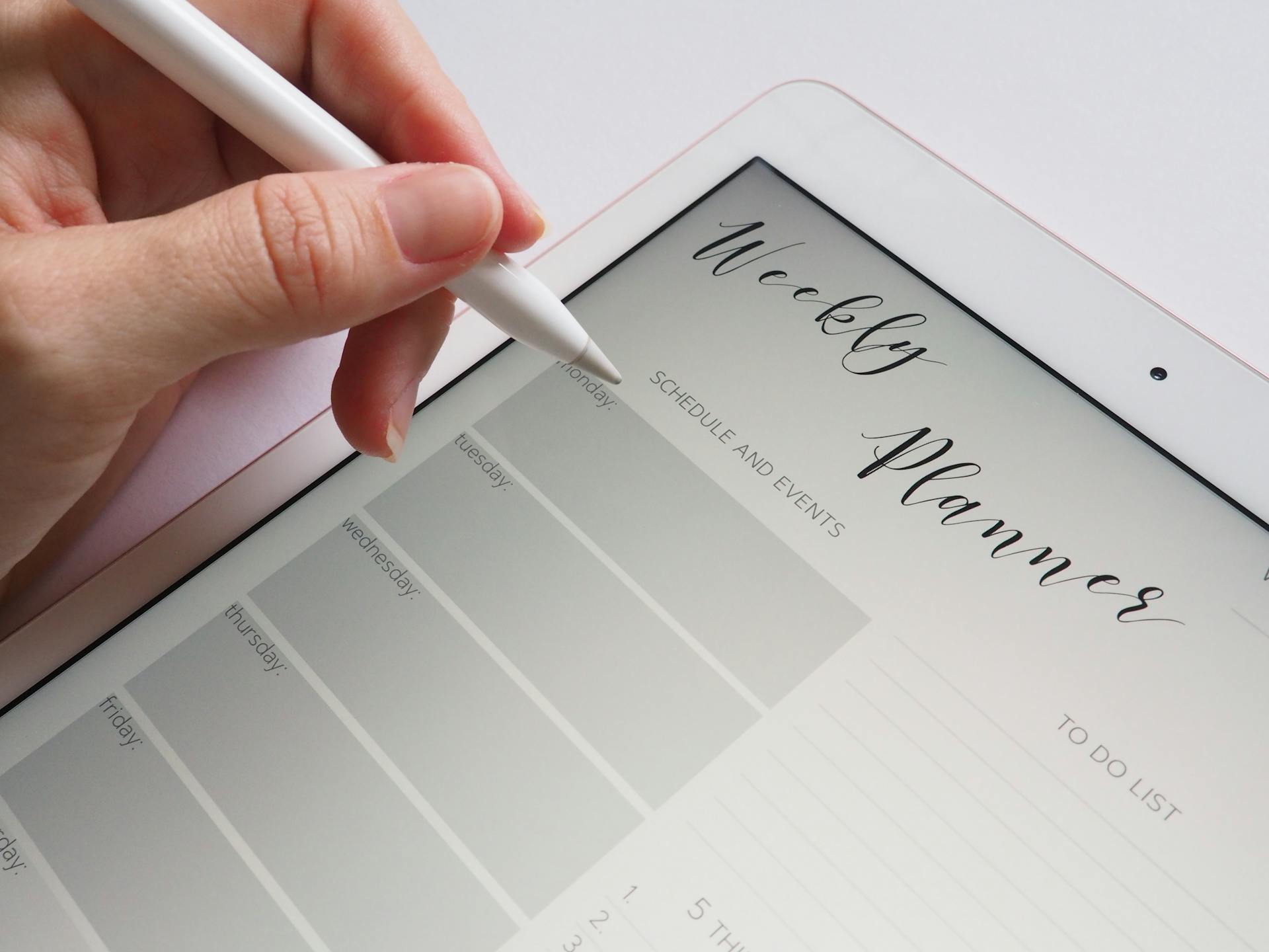 Writing on an electronic planner | Source: Pexels