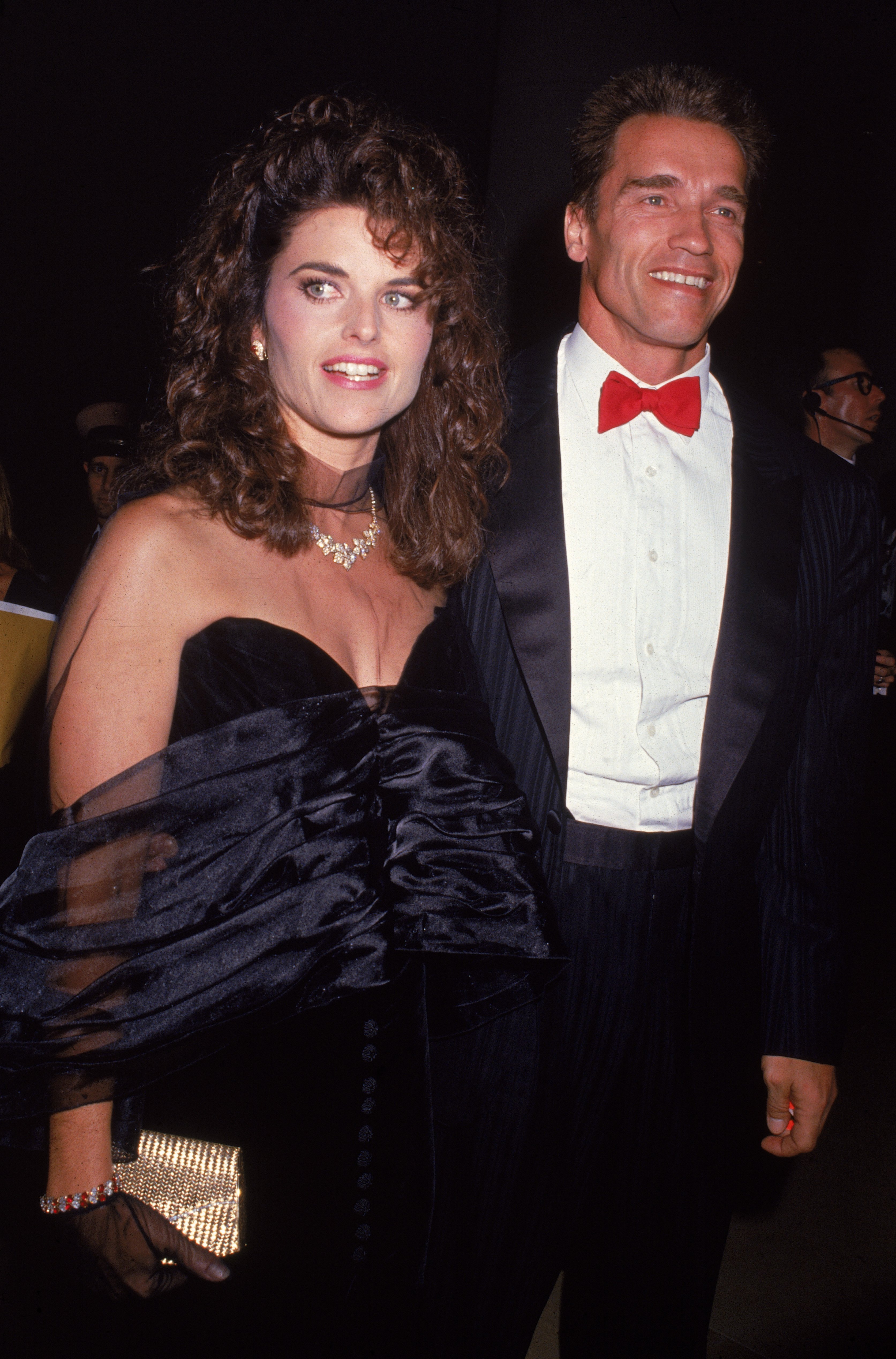 Austrian born actor Arnold Schwarzenegger and wife Maria Shriver stand dressed in formal wear at an event, circa 1986. | Source: Getty Images