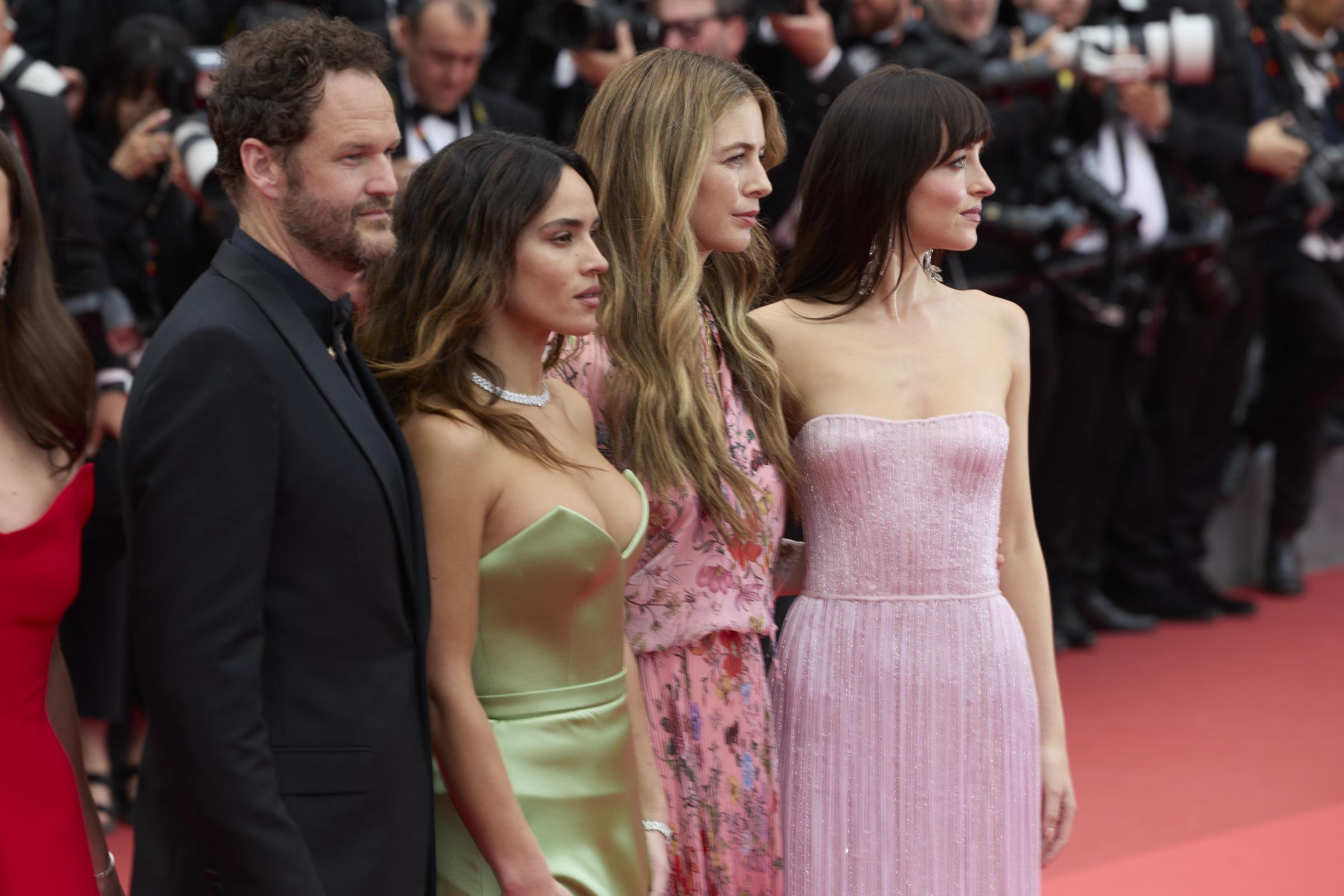 Kyle Marvin, Adria Arjona, Ro Donnelly, and Dakota Johnson pose together on the red carpet at the Cannes Film Festival.