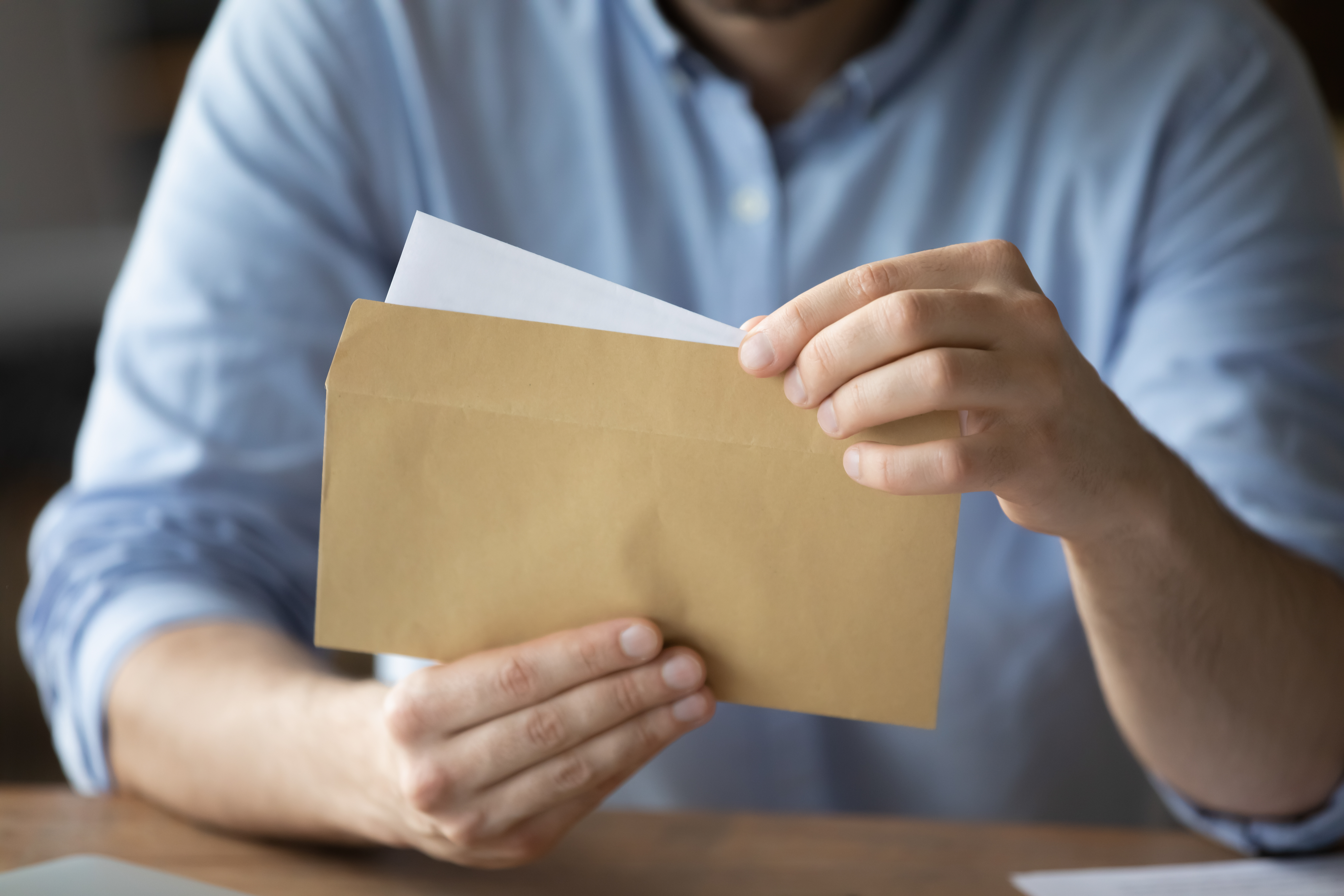 A man opening a letter | Source: Shutterstock