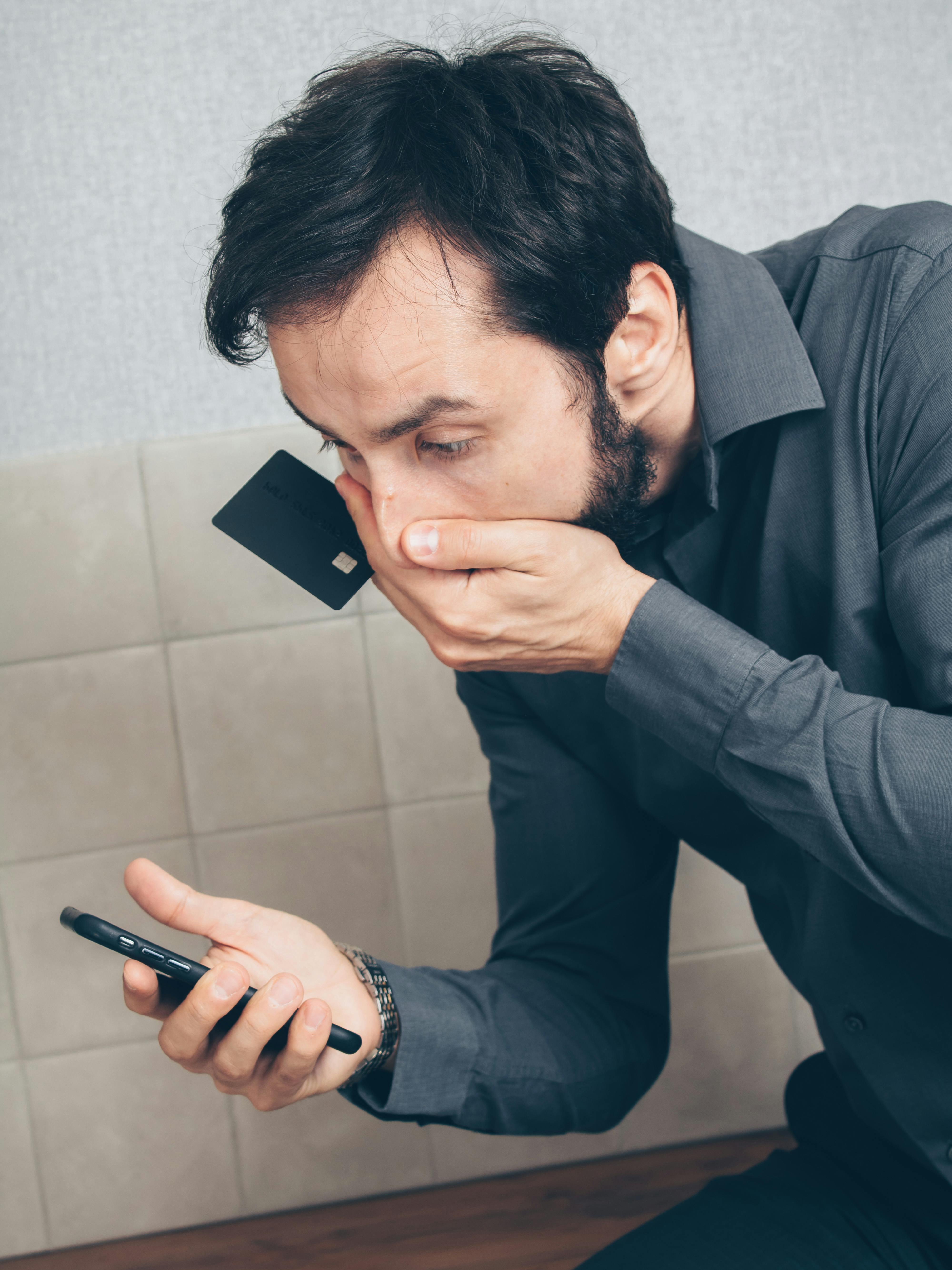 A shocked man looking at his phone | Source: Pexels