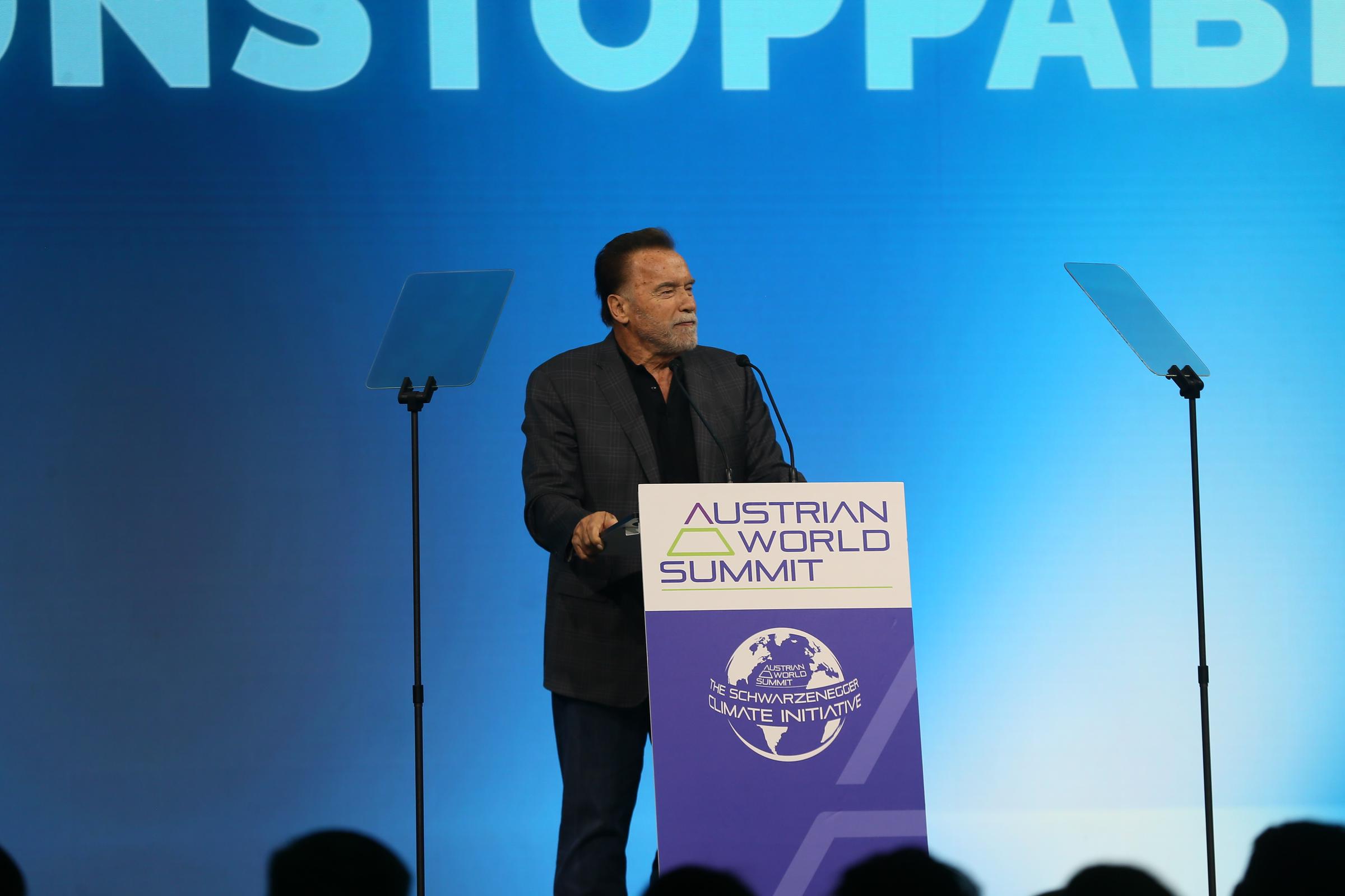 He and his longtime girlfriend Heather Milligan showed up together for a rare outing. In this photo, Arnold Schwarzenegger speaks at the "10th Austrian World Summit" climate conference at the Hofburg Palace on June 16, 2026, in Vienna, Austria. | Source: Getty Images