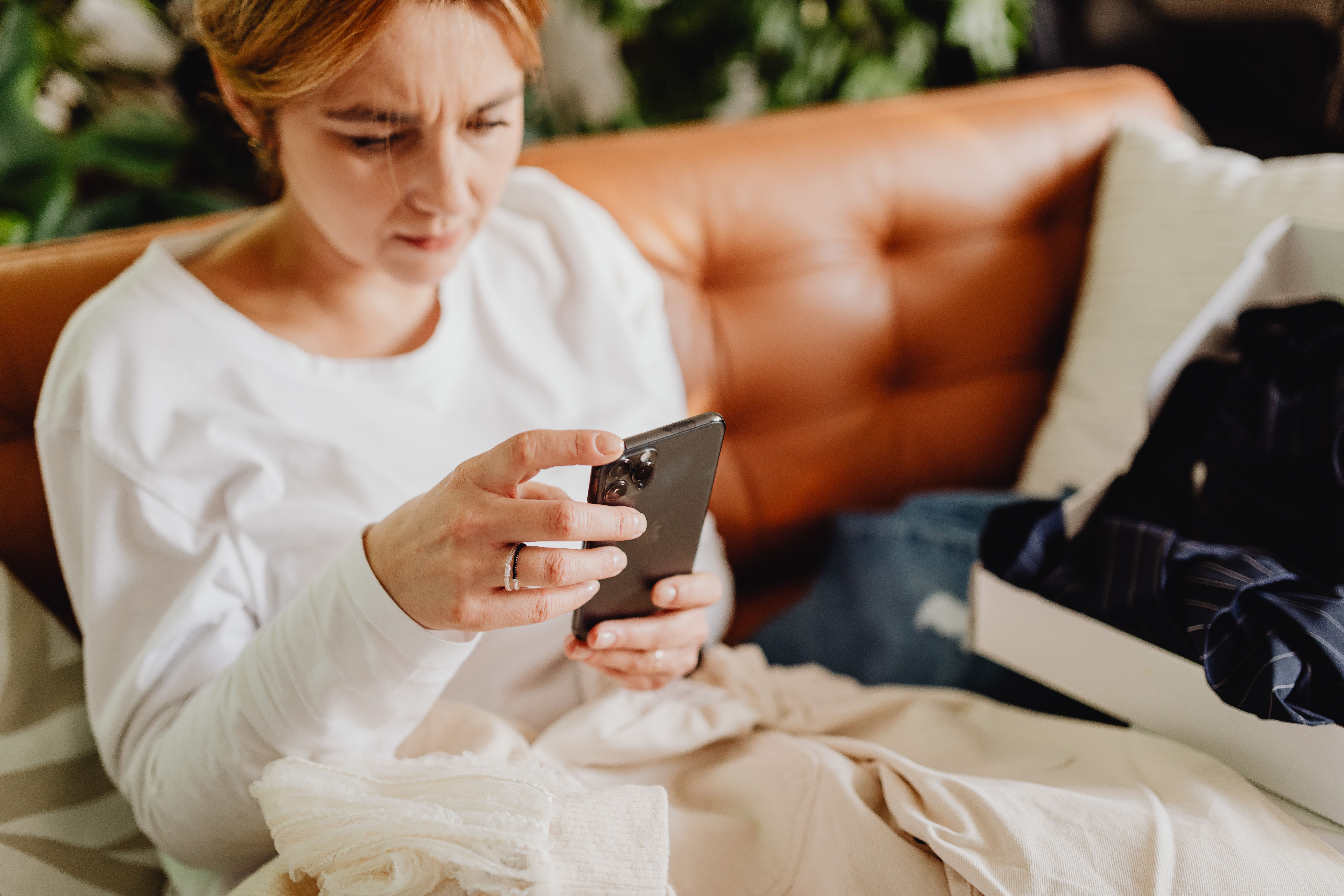 A woman intently viewing her smartphone | Source: Pexels