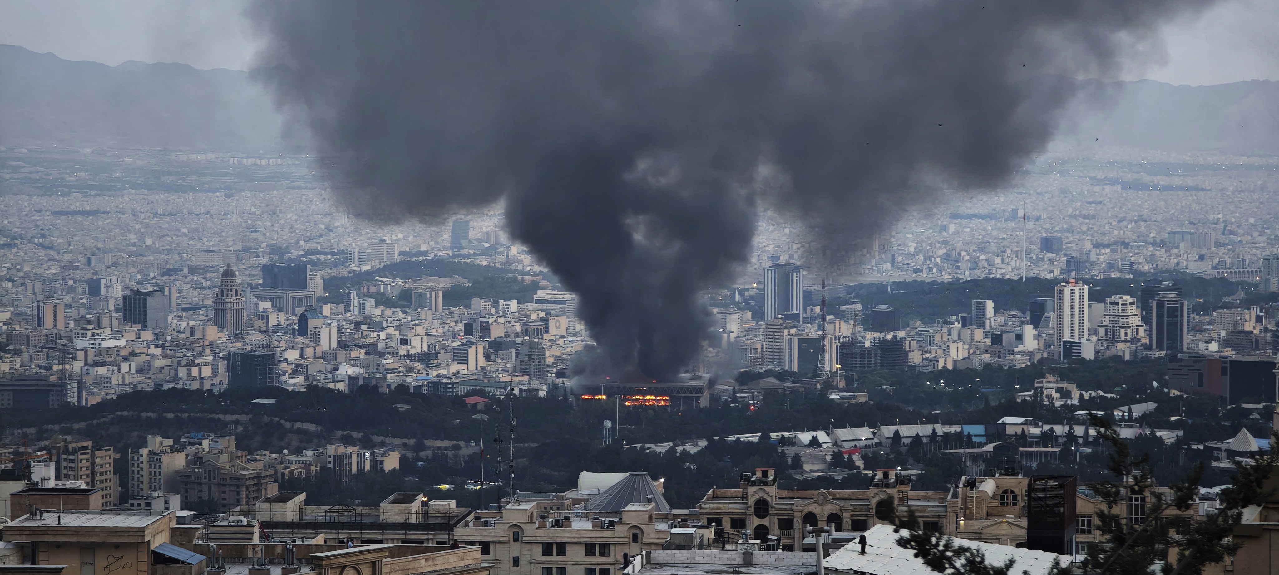 Smoke rises after a reported Israeli strike on a building used by Islamic Republic of Iran News Network on June 16, 2025 in Tehran, Iran. | Source: Getty Images