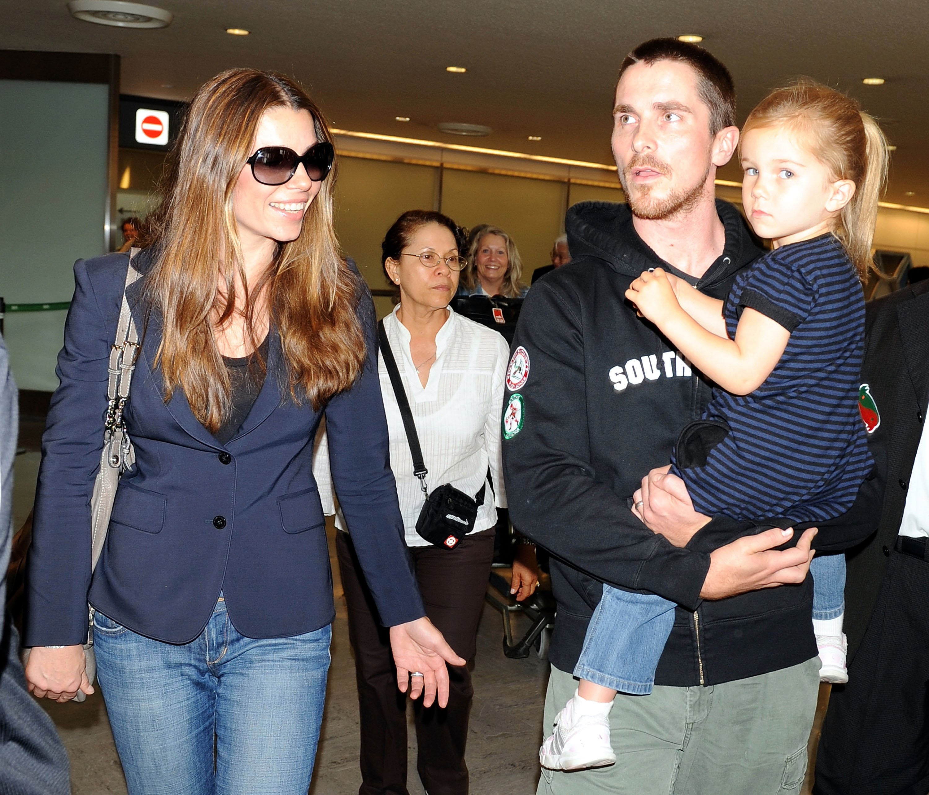 Actor Christian Bale (R) with his daughter and Sibi Bale (L) arrive at Narita International Airport for the promotion of "The Dark Knight" on July 26, 2008 in Narita, Chiba, Japan. | Source: Getty Images