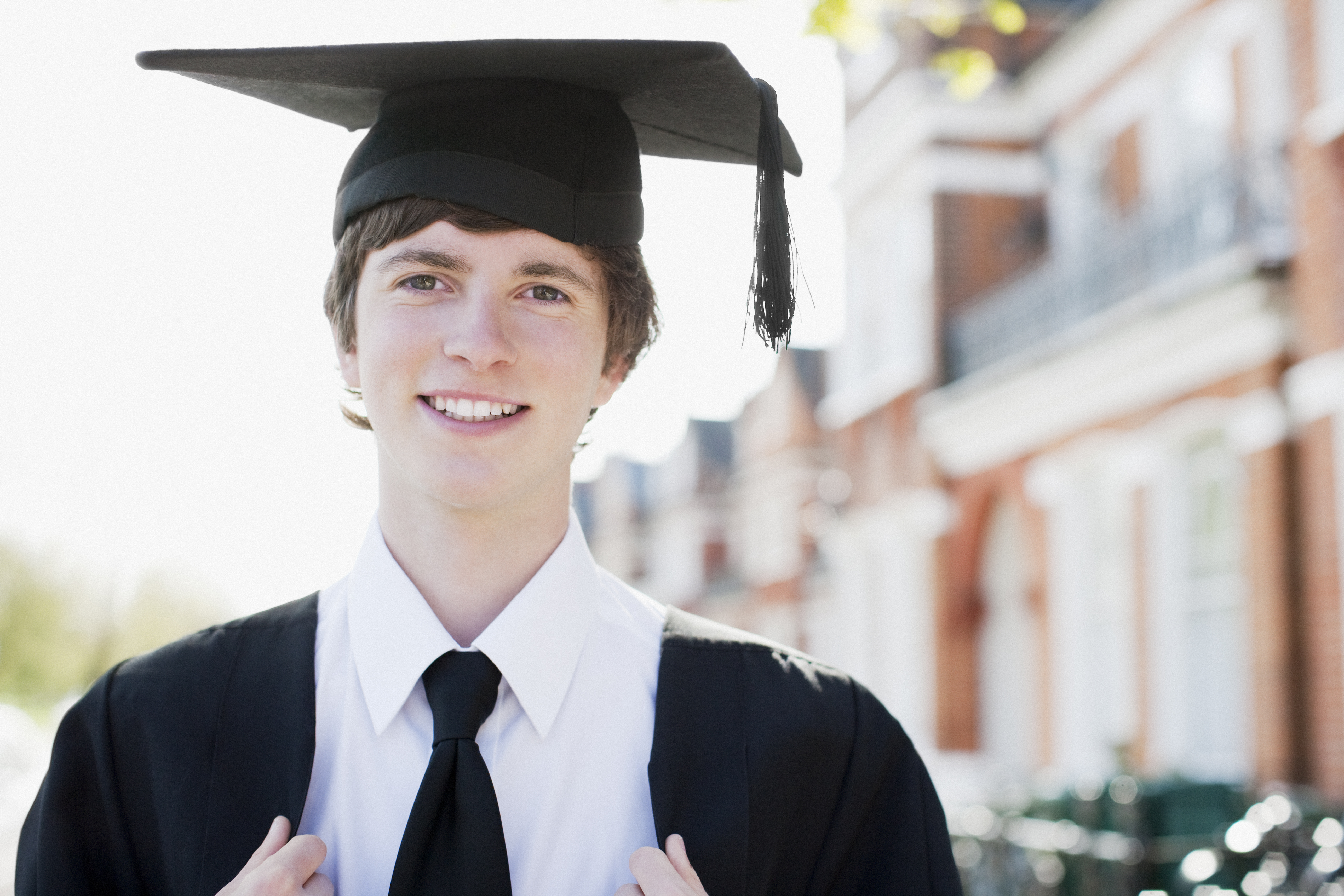 A young man wearing a graduation cap and gown | Source: Getty Images