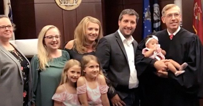The Downing’s standing with a judge who is holding Livyia Downing.│ youtube.com/11Alive
