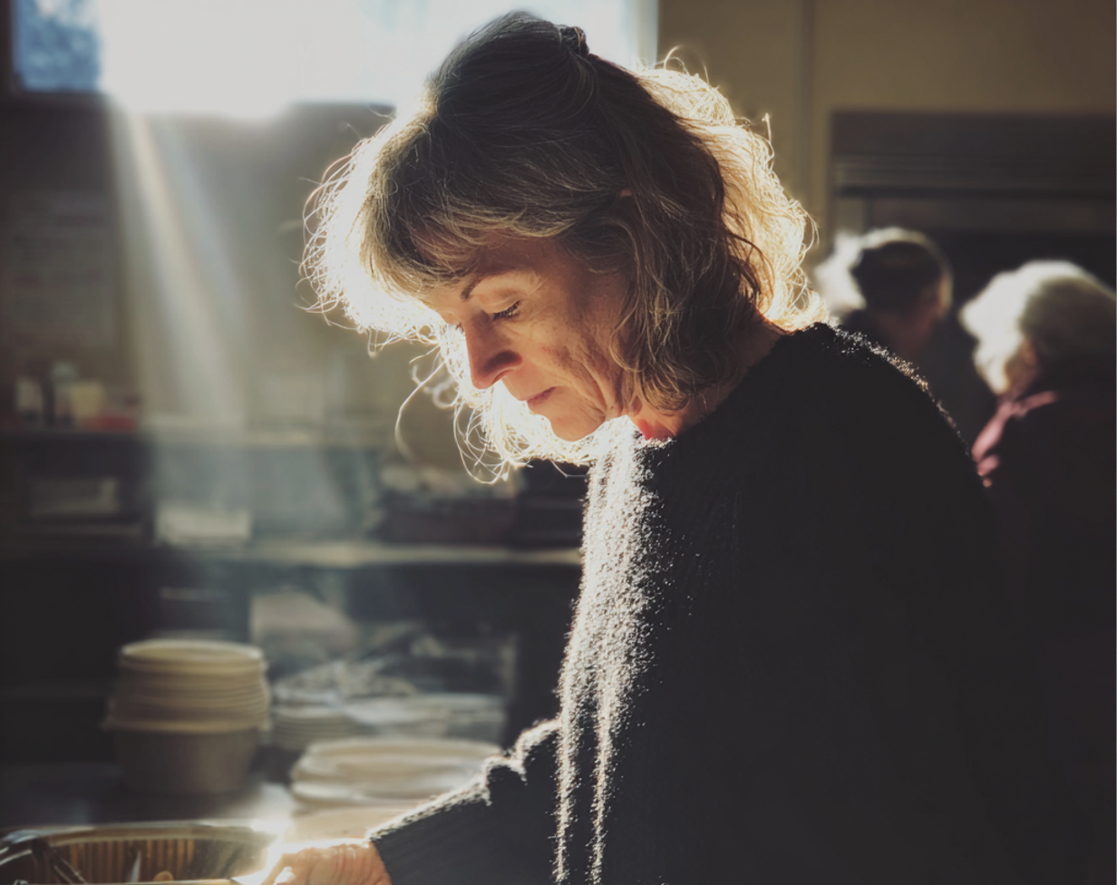 A woman busy in a soup kitchen | Source: Midjourney