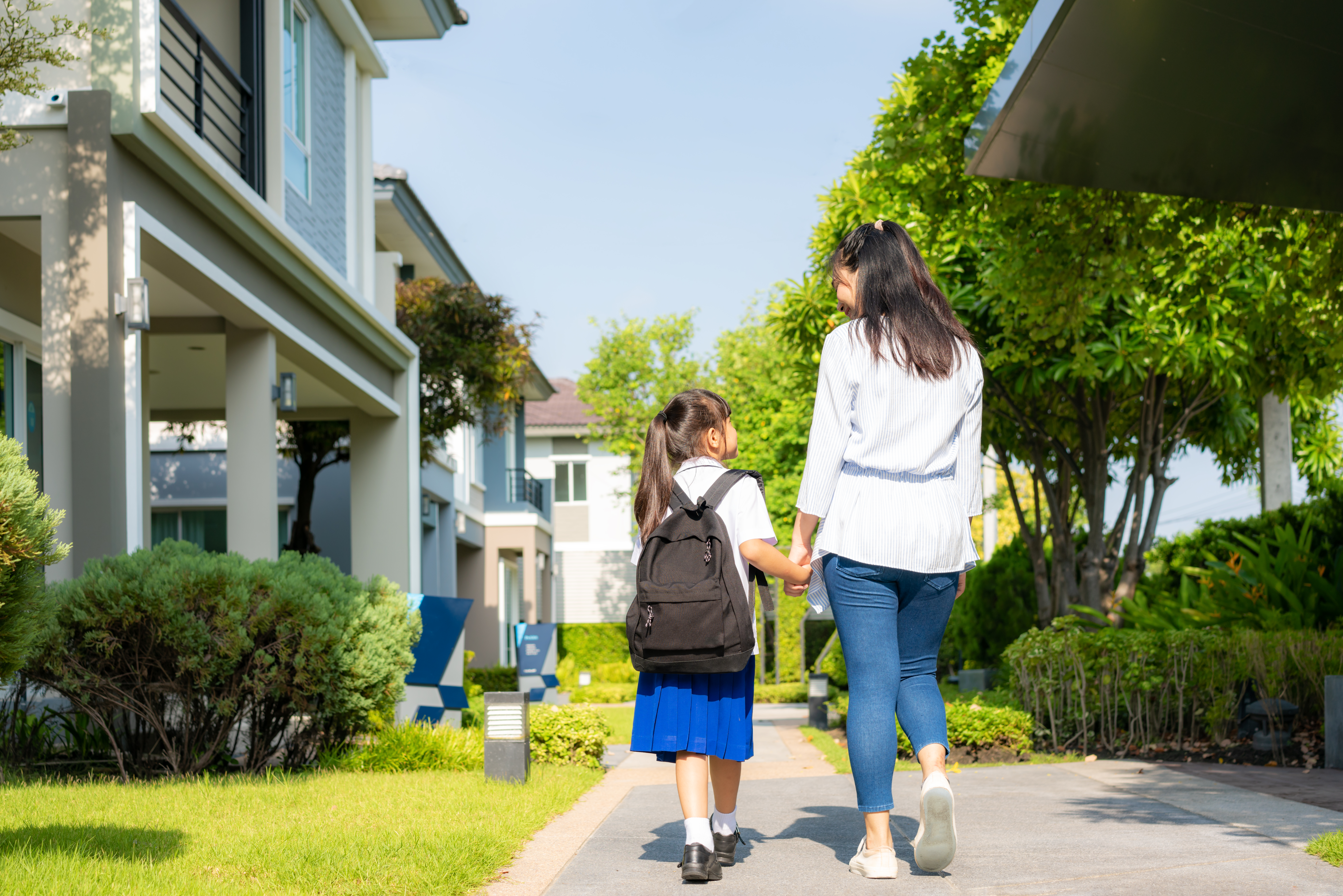 Happy Asian mother and daughter primary school student walking to school in the morning school routine for day in the life getting ready for school | Source: Getty Images