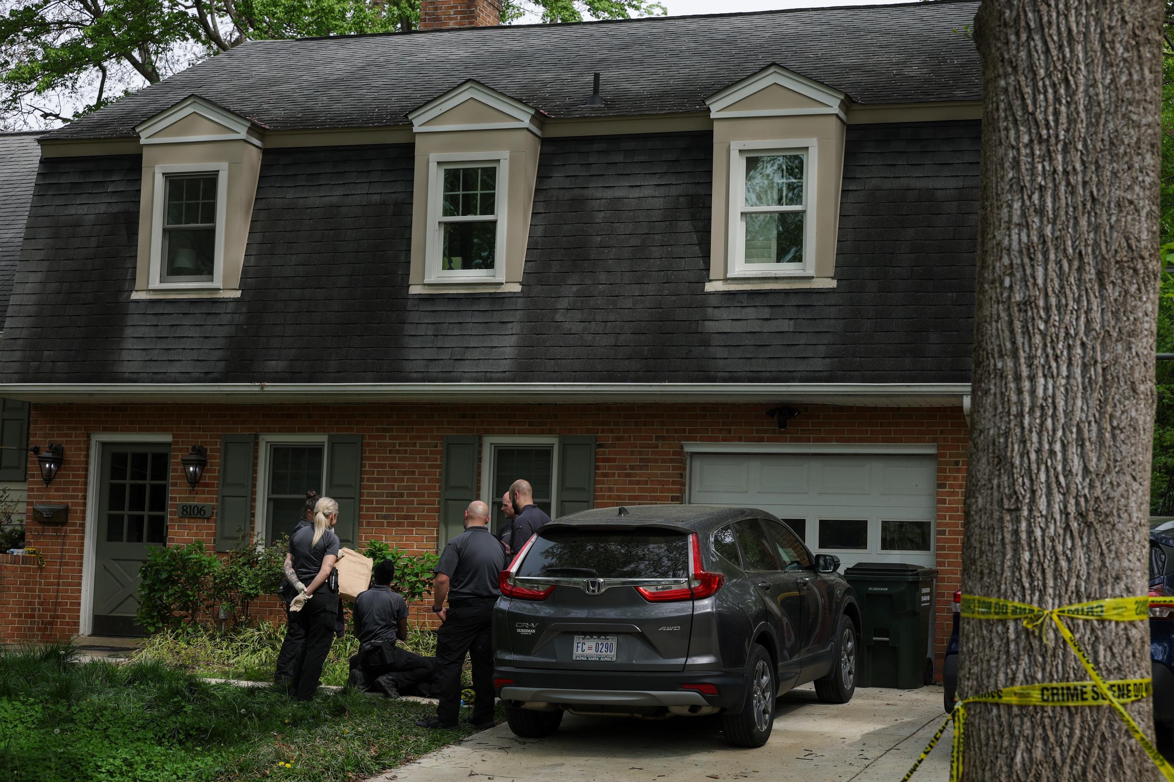 Investigators gather near the driveway beside a vehicle while continuing work at the scene in Annandale, Virginia on April 16, 2026 | Source: Getty Images