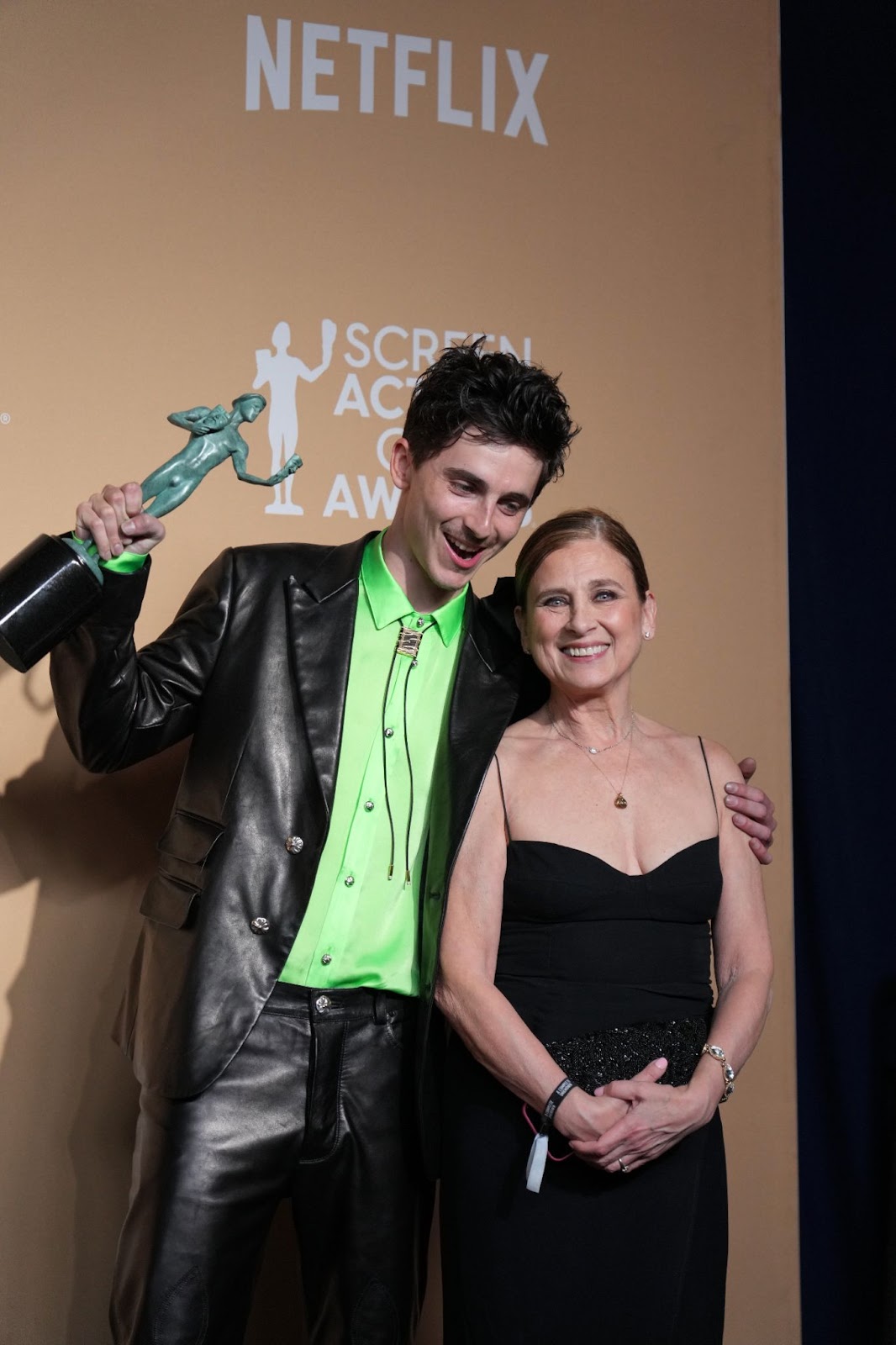 Timothée Chalamet holds his Outstanding Performance by a Male Actor in a Leading Role award while posing with Nicole Flender | Source: Getty Images