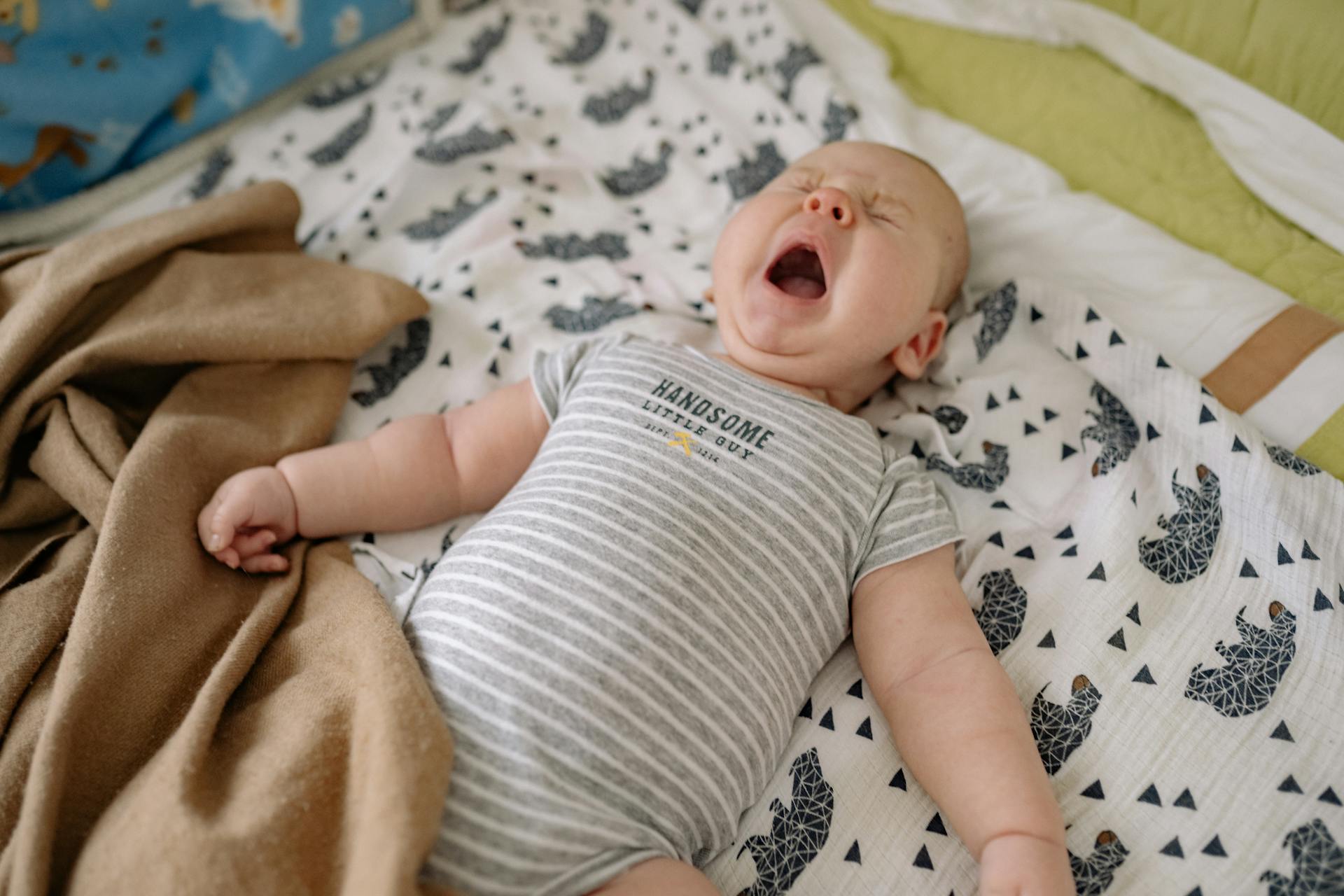 A crying baby lying on the bed | Source: Pexels