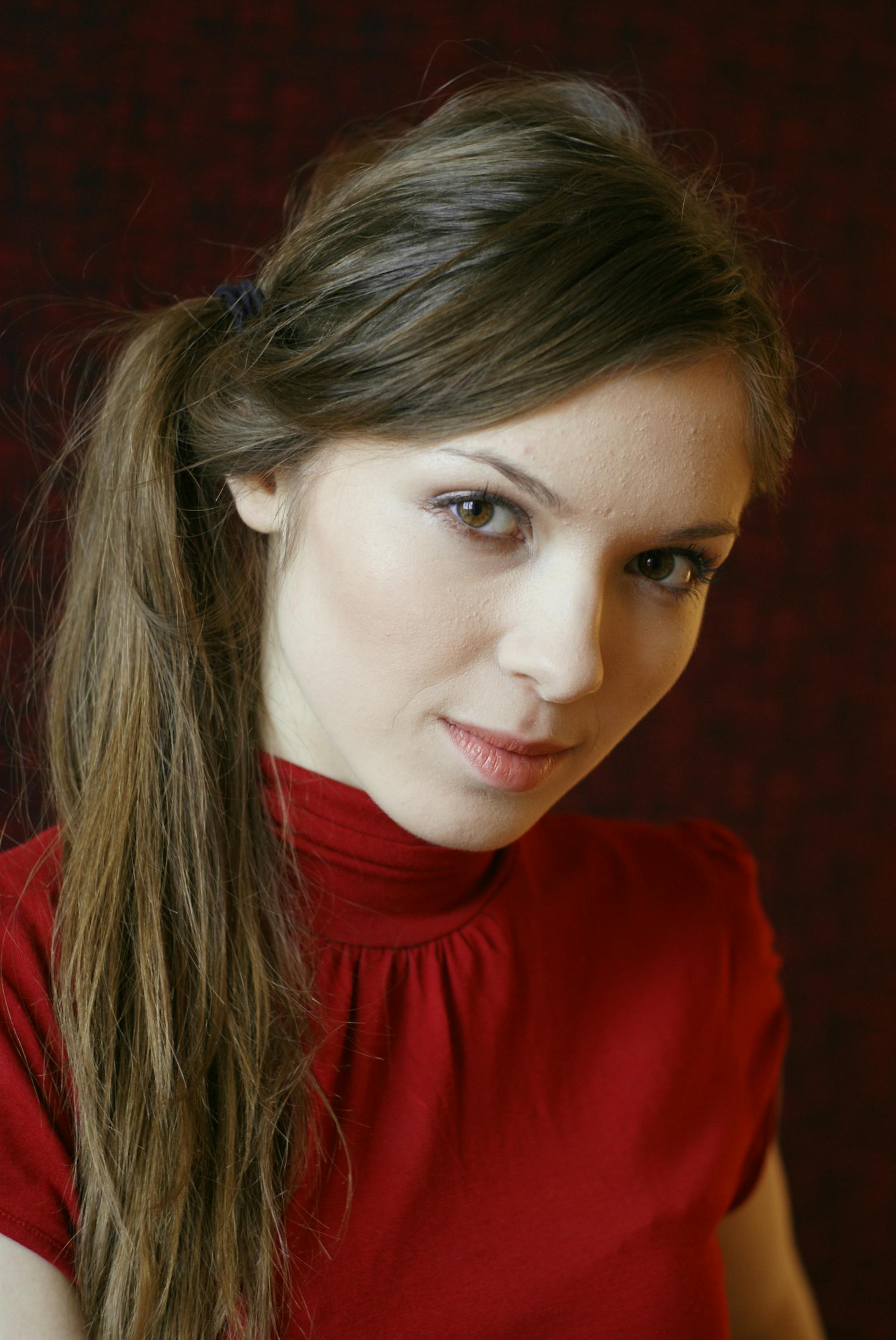 A woman in a red dress looking at someone | Source: Pexels