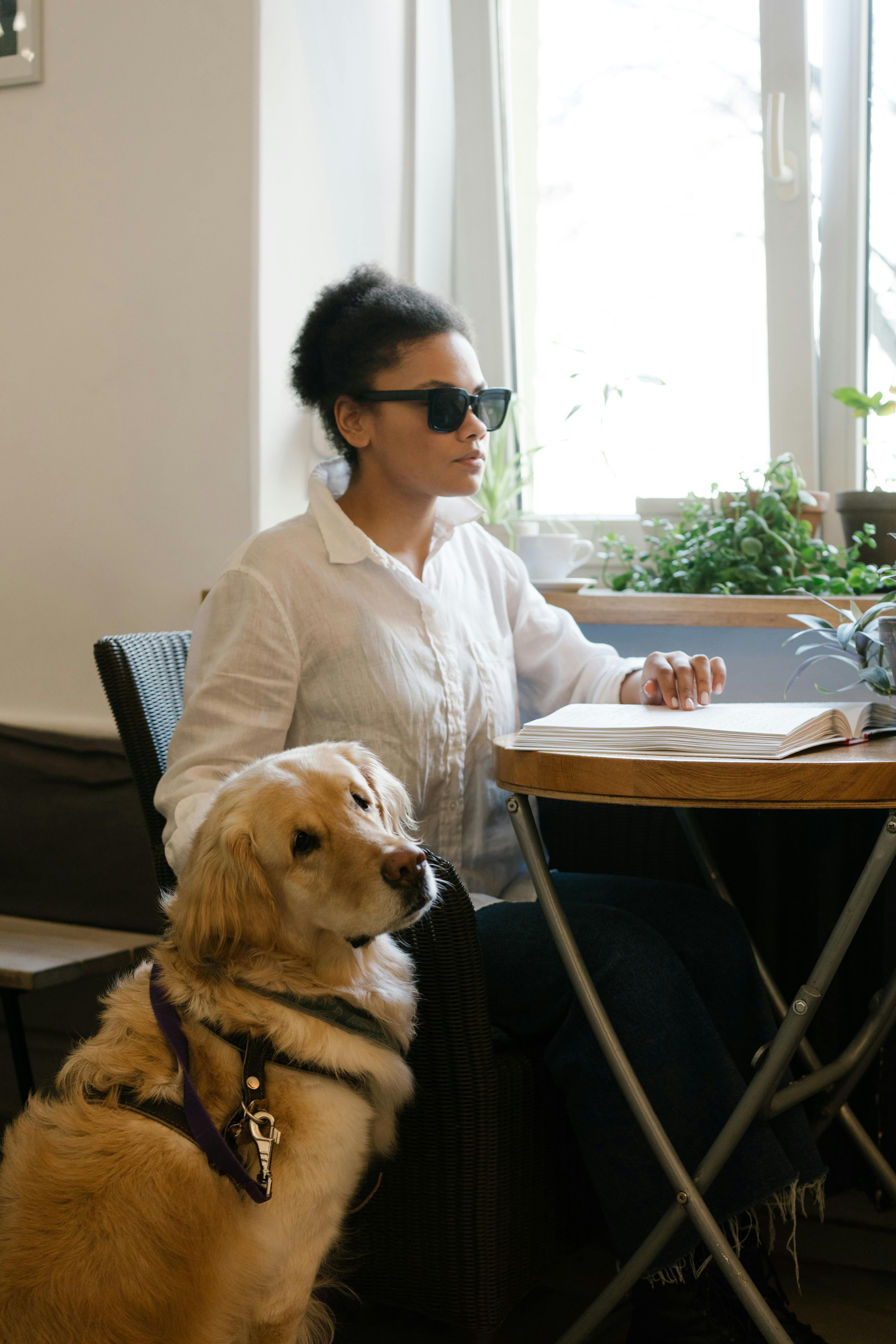 A blind woman reading braille in a café | Source: Pexels