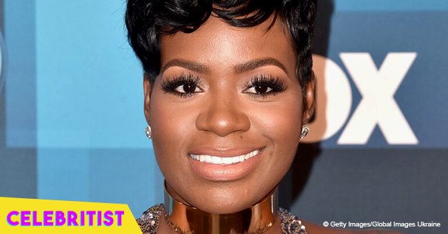 Fantasia flaunts pink manicure, posing in white blouse & denim jeans next to husband in new pic