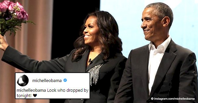 Barack Obama surprises wife Michelle with bouquet of flowers at her book tour event in Washington