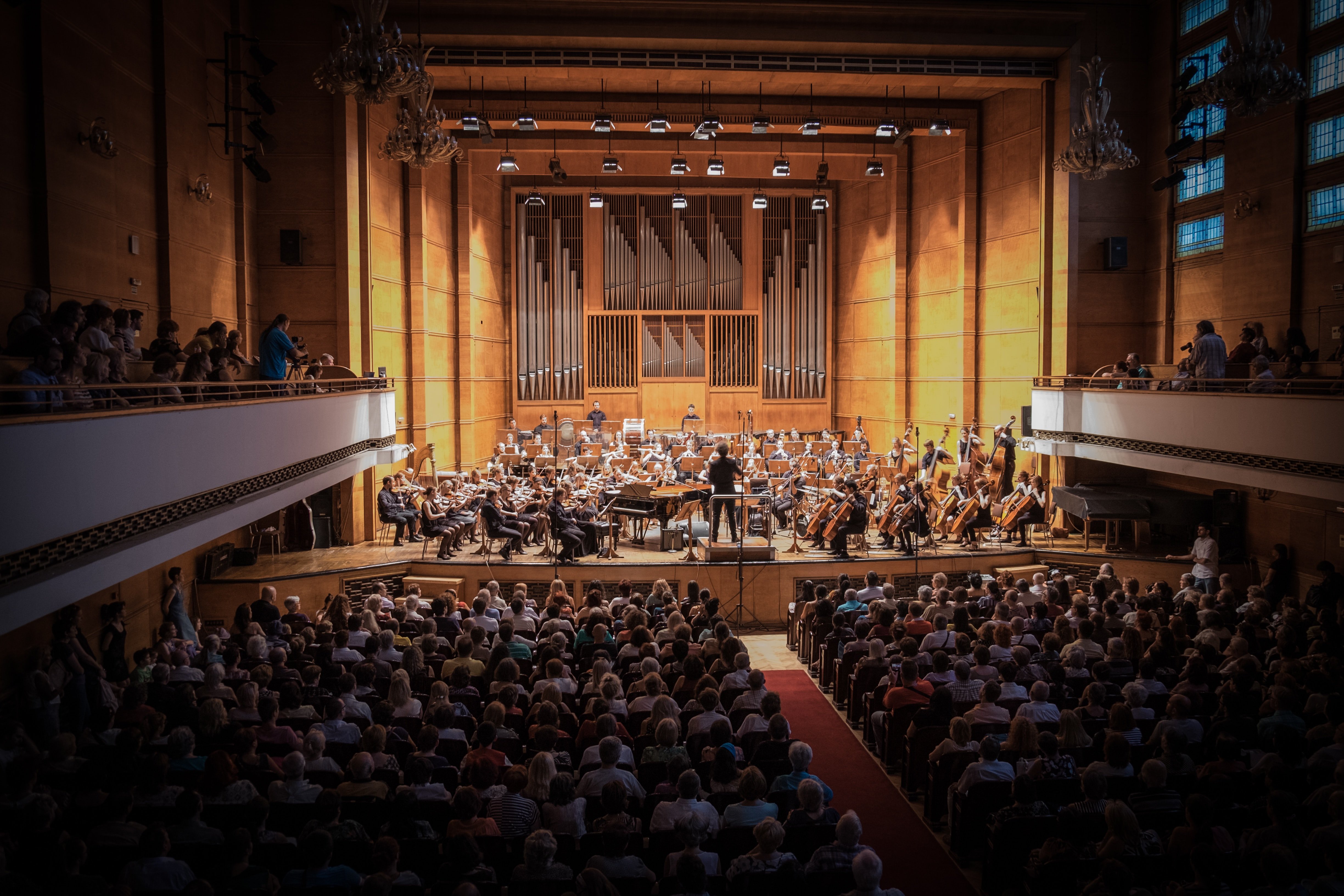 The conductor taking center stage in the orchestra | Source: Unsplash.com