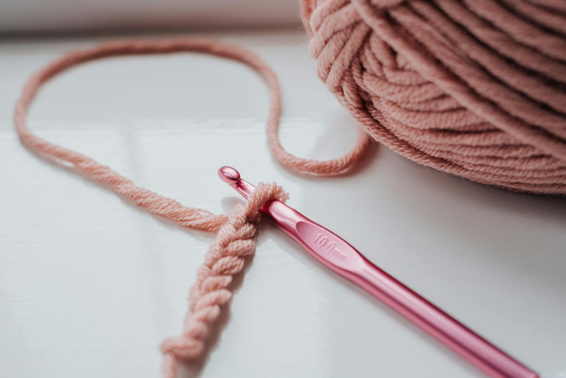 A knitted piece and yarn with hook | Source: Pexels