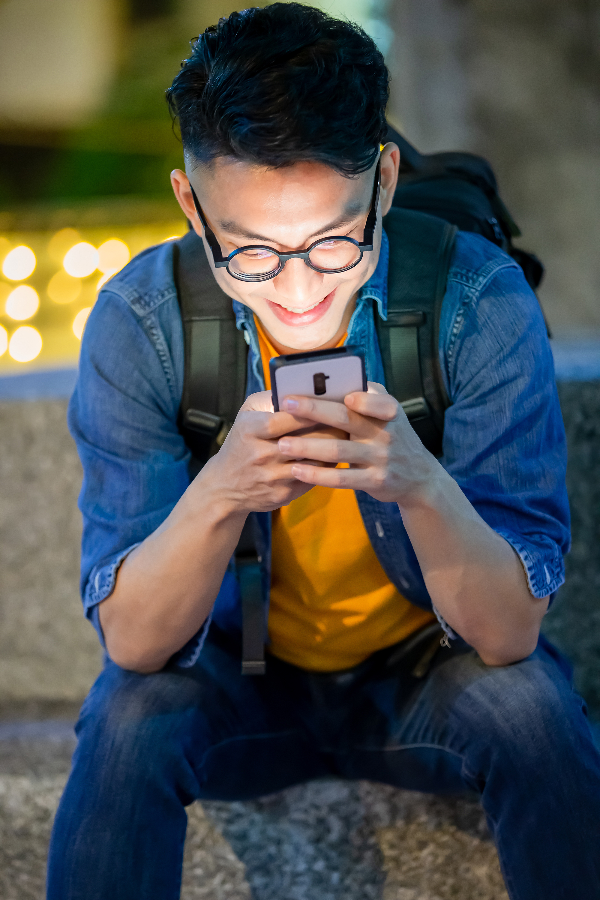 A young man using his phone | Source: Shutterstock