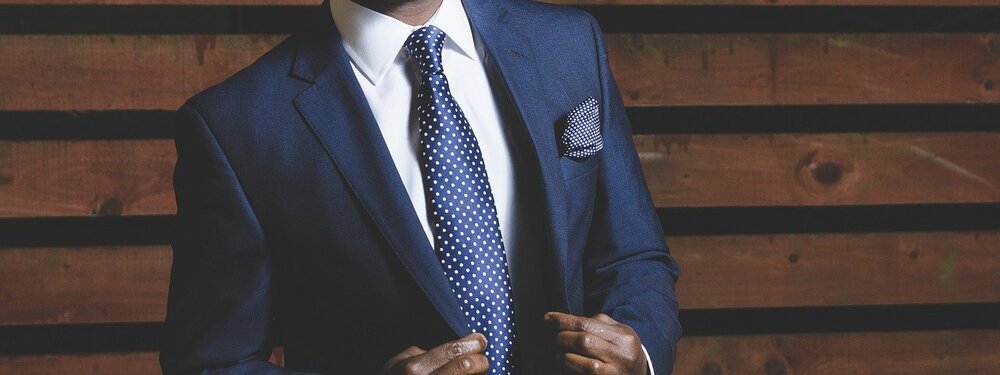 Businessman wearing a suit. | Image: Pixabay.