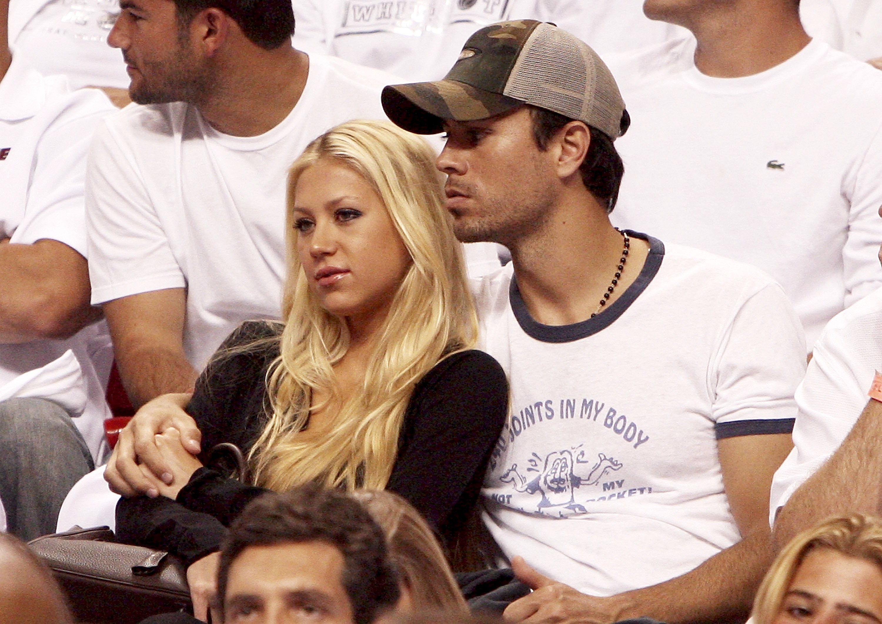 Former tennis player Anna Kournikova and singer Enrique Iglesias watch the New Jersey Nets take on the Miami Heat in game one of the Eastern Conference semifinals at American Airlines Arena, on May 8, 2006, in Miami, Florida. | Source: Getty Images