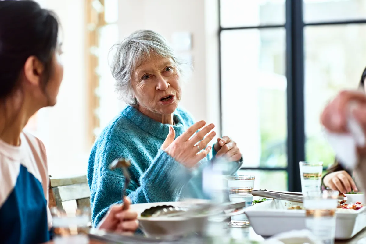 A grandmother telling stories at the dinner table | Source: Getty Images