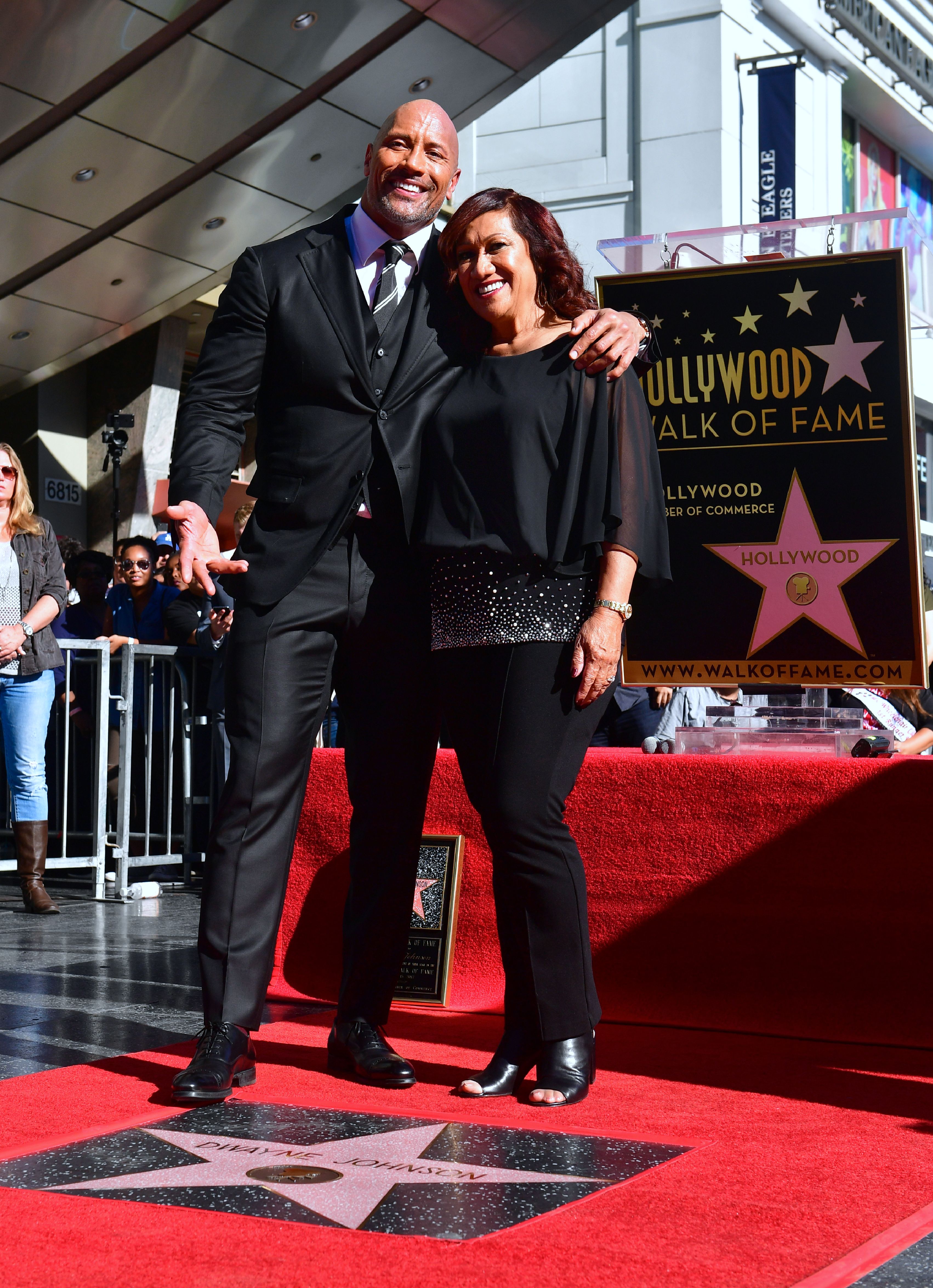 Dwayne Johnson poses with his mother, Ata Johnson, at his Hollywood Walk of Fame Star ceremony in Hollywood, California on December 13, 2017. | Source: Getty Images