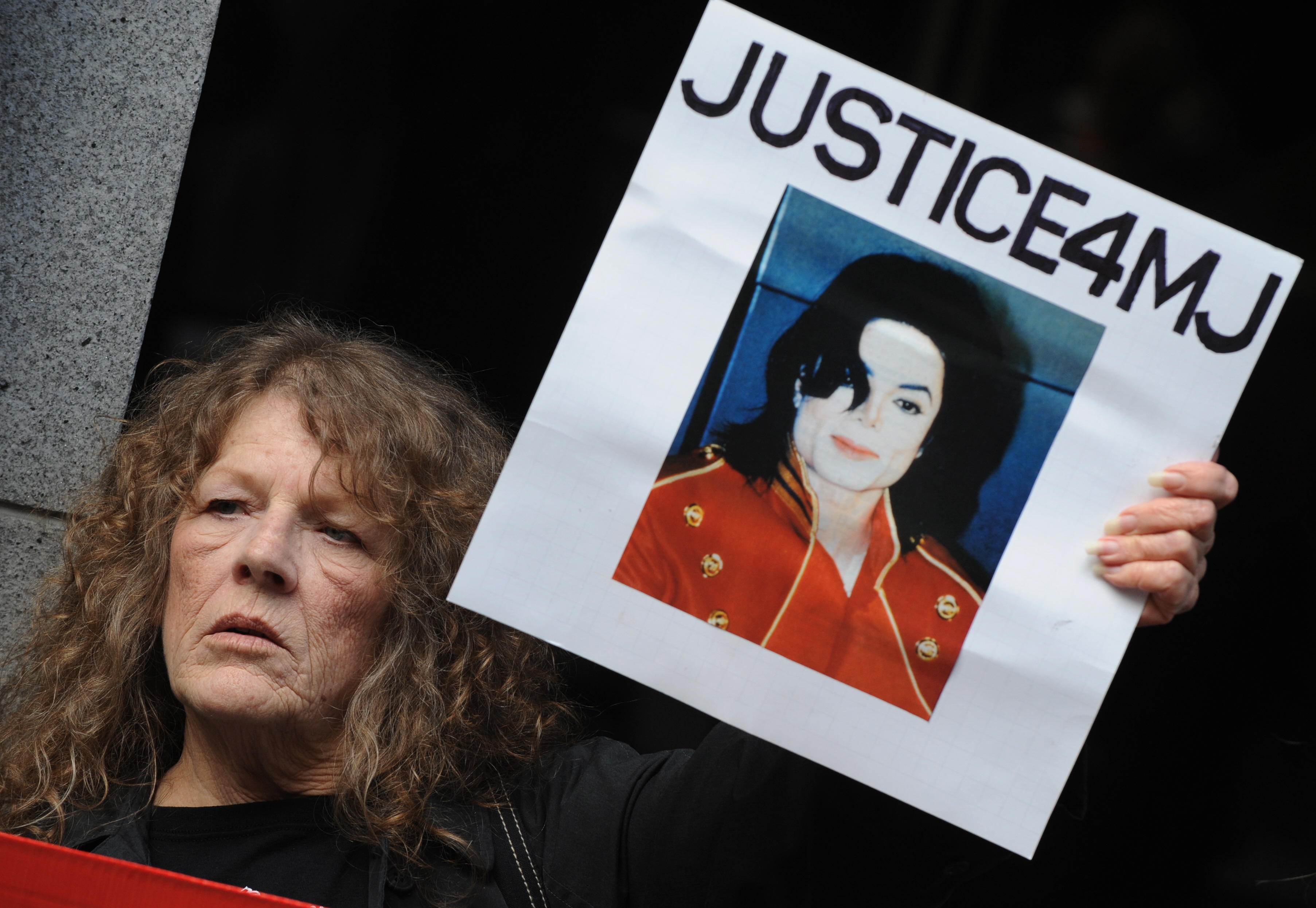 Michael Jackson fans call for justice outside the Los Angeles Superior Court before Doctor Conrad Murray's second court appearance on an involuntary manslaughter charge relating to the death of Michael Jackson in downtown Los Angeles on April 5, 2010. | Source: Getty Images
