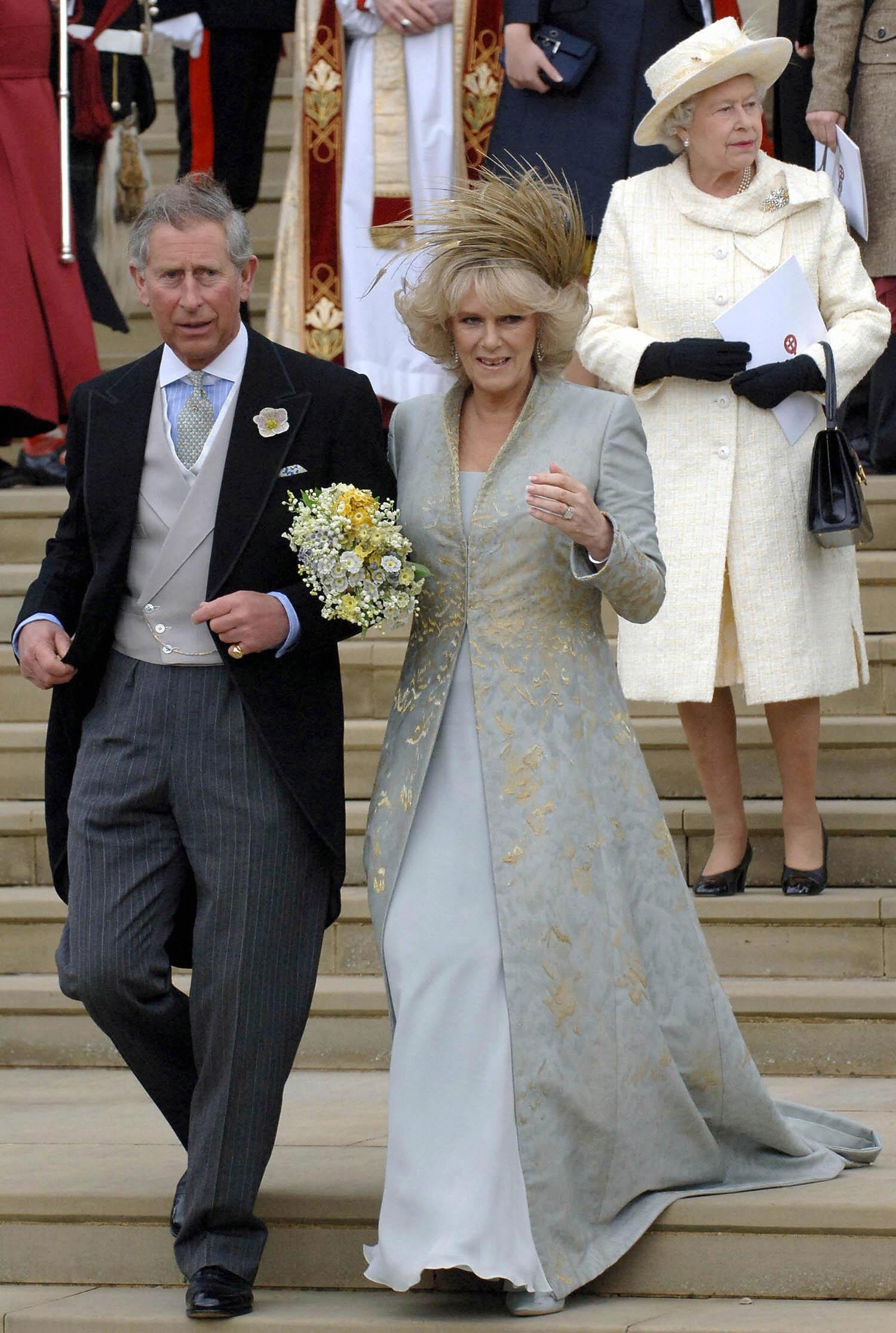Queen Elizabeth II pictured behind Prince Charles and his wife Camilla Duchess of Cornwall walking down the steps of St. George's Chapel in Windsor following the church blessing of their civil wedding ceremony, 09 April 2005 | Source: Getty Images