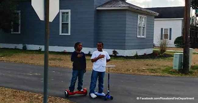 Boys stop to declare Pledge of Allegiance next to a flag outside North Carolina fire dept.