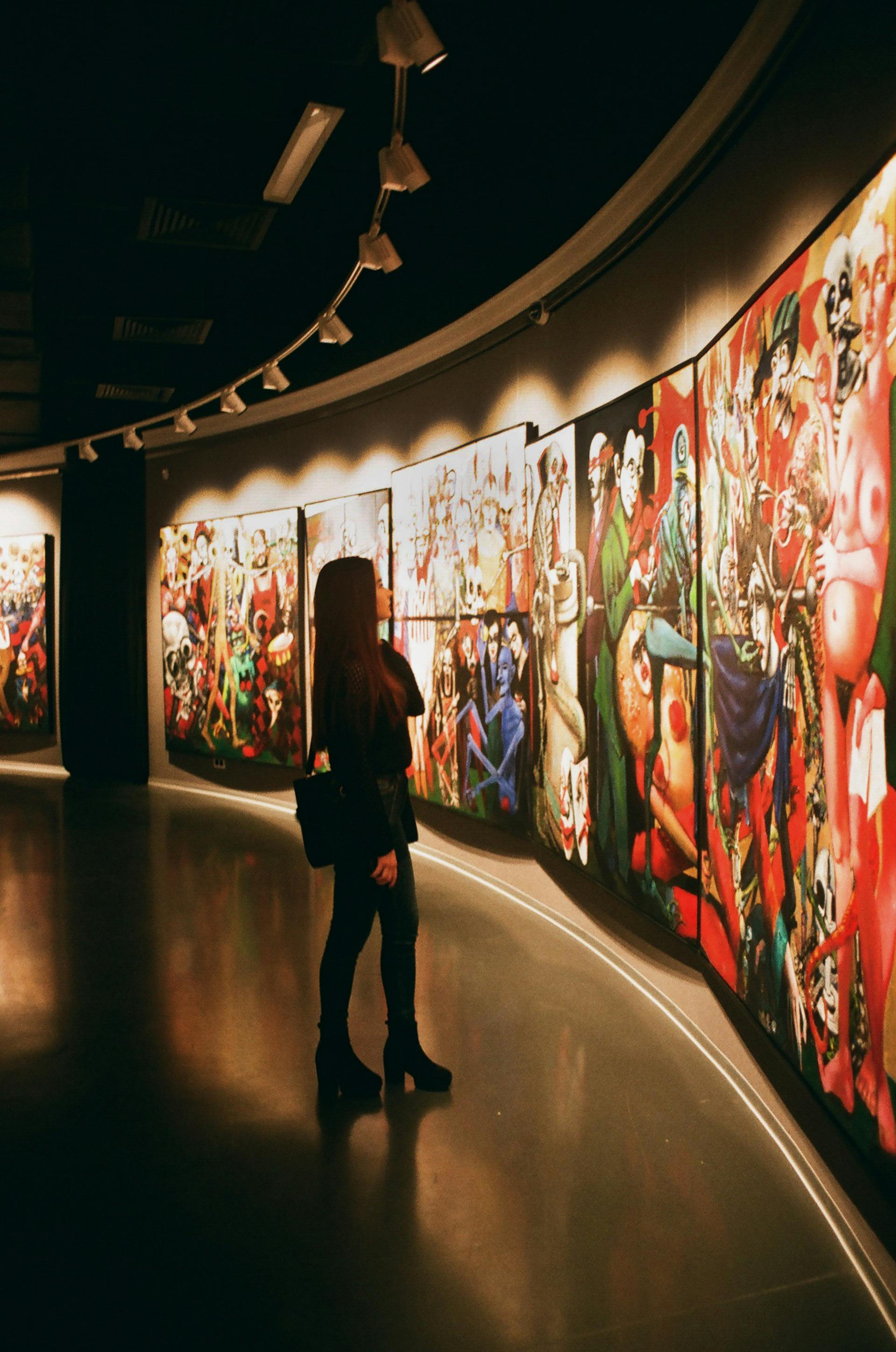 A woman looking at paintings in an art gallery | Source: Pexels