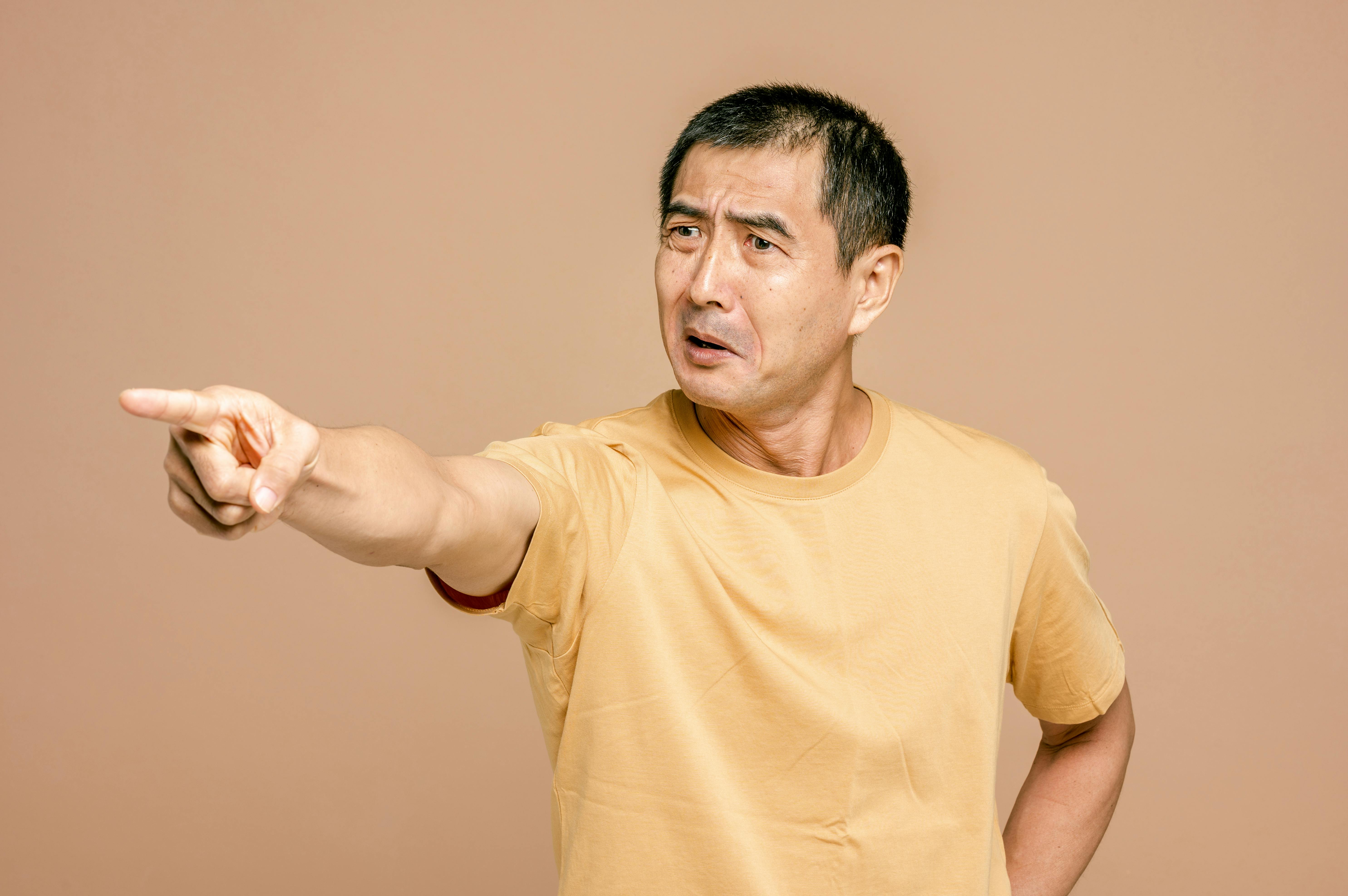 An upset man pointing a finger while reacting to something | Source: Pexels